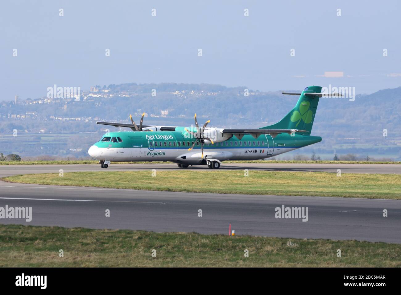 A small Aer Lingus regional airline propeller plane at Bristol International Airport about to take off on the runway Stock Photo