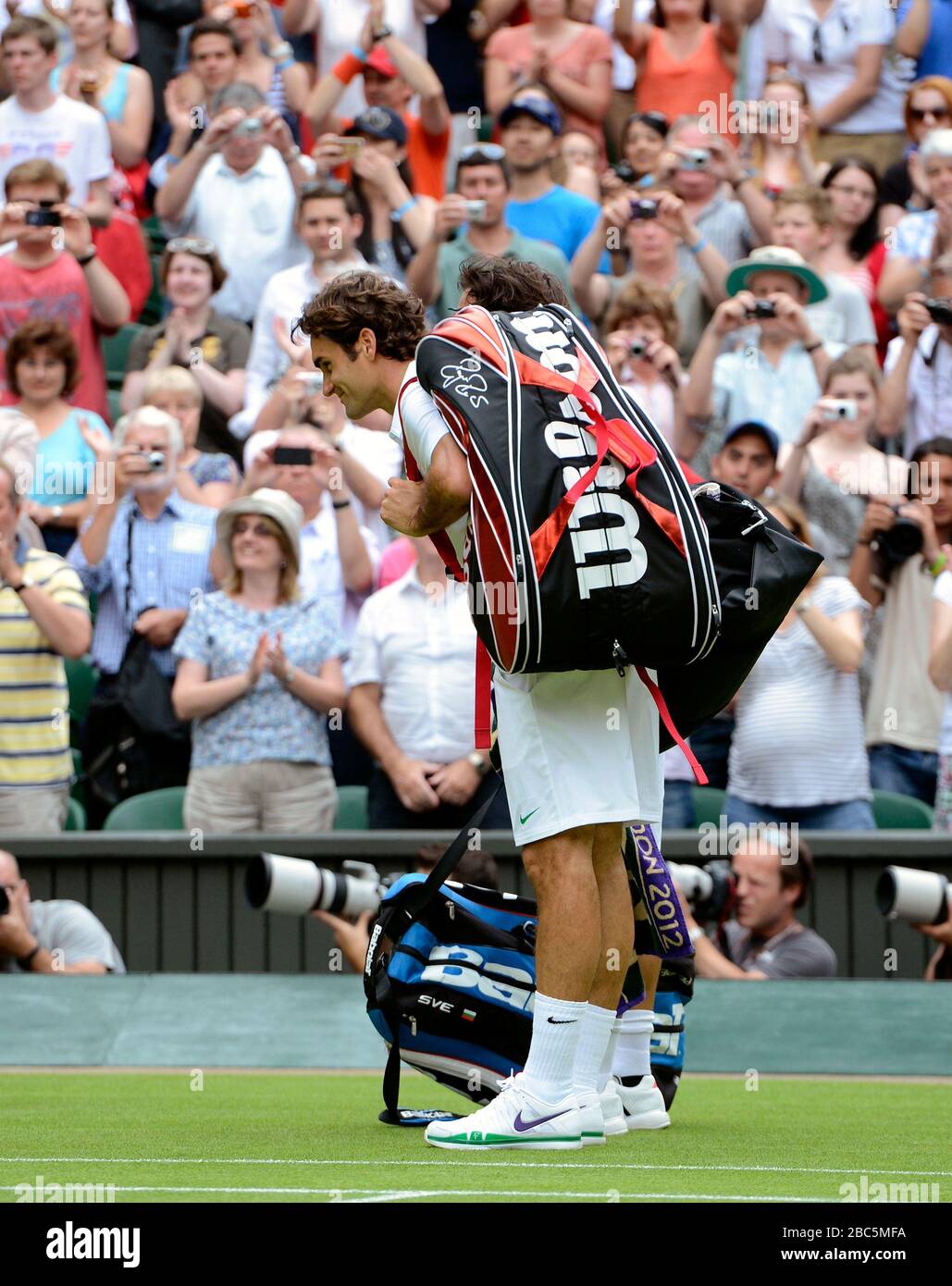 Switzerland's Roger Federer and Italy's Fabio Fognini bow to the Royal Box Stock Photo