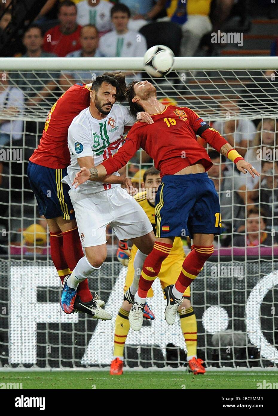Portugal's Hugo Miguel Almeida (centre) battles for the ball with Spain's Gerard Pique (left) and Garcia Sergio Ramos (right) Stock Photo