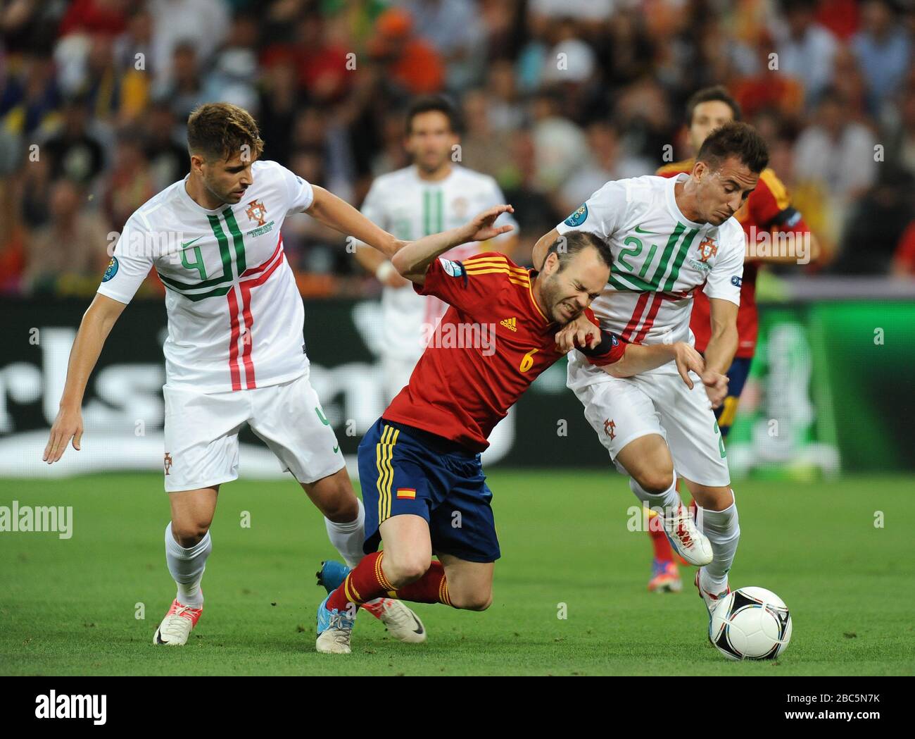Spain's Andres Iniesta tackled by Portugal's Miguel Veloso and  Joao Pereira Stock Photo