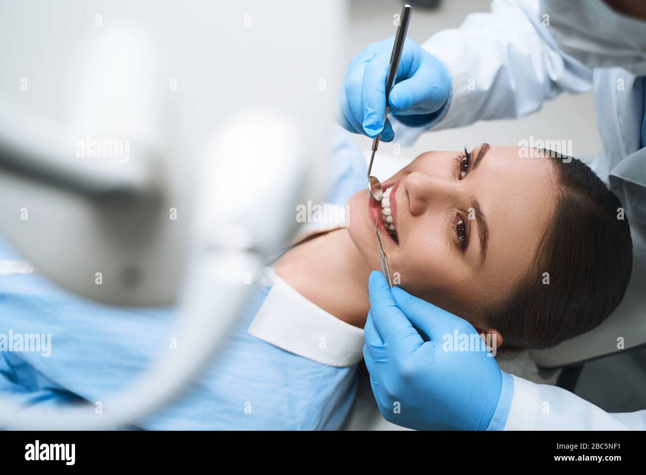 Merry girl being examined by dentist stock photo Stock Photo