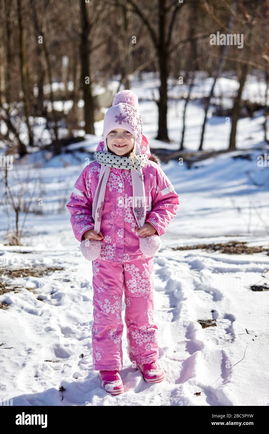 Little Toddler Girl In Winter Clothes Walks By Snow At Showfall Stock  Photo, Picture and Royalty Free Image. Image 15648359.