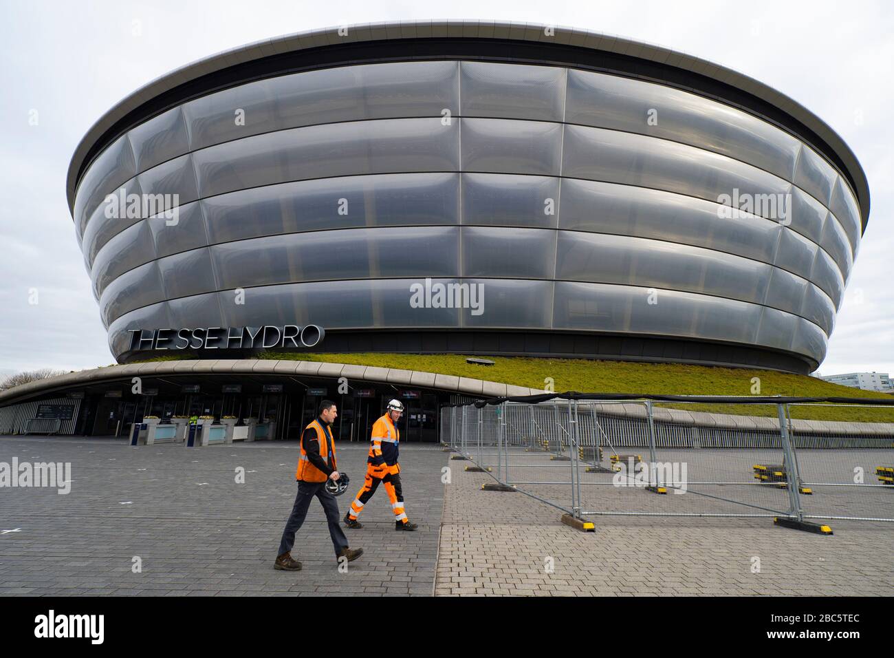 Glasgow, Scotland, UK. 3 April, 2020. Exterior view of workers walking past SSE hydro  during building of temporary  NHS Louisa Jordan field hospital at the Scottish Events Campus (SEC) in Glasgow.  Iain Masterton/Alamy Live News Stock Photo