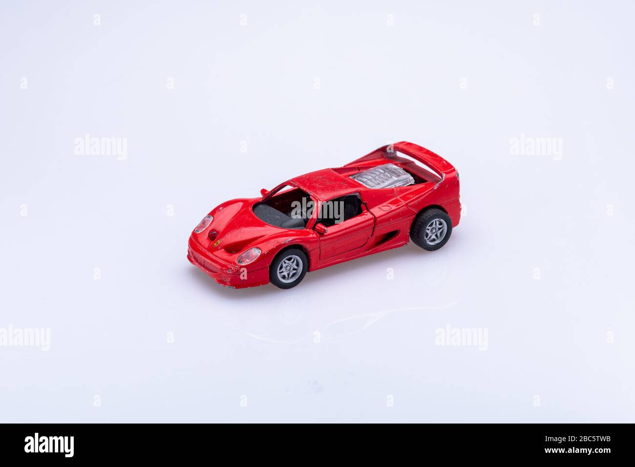 small old fashion car toy isolated in front a white background Stock Photo