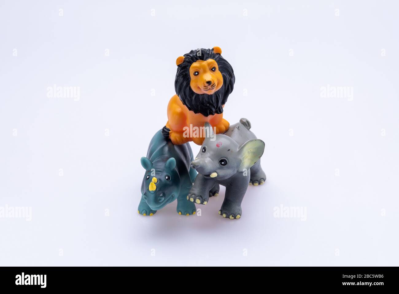 Rhinoceros, lion and elephant toys isolated in front a white background Stock Photo