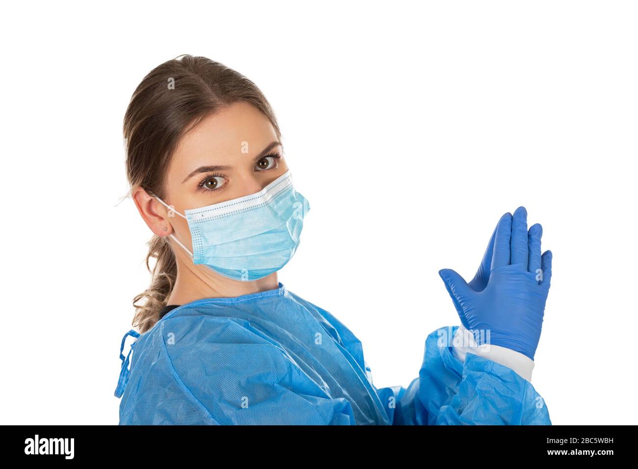 Young medical nurse wearing blue protective uniform on isolated ...