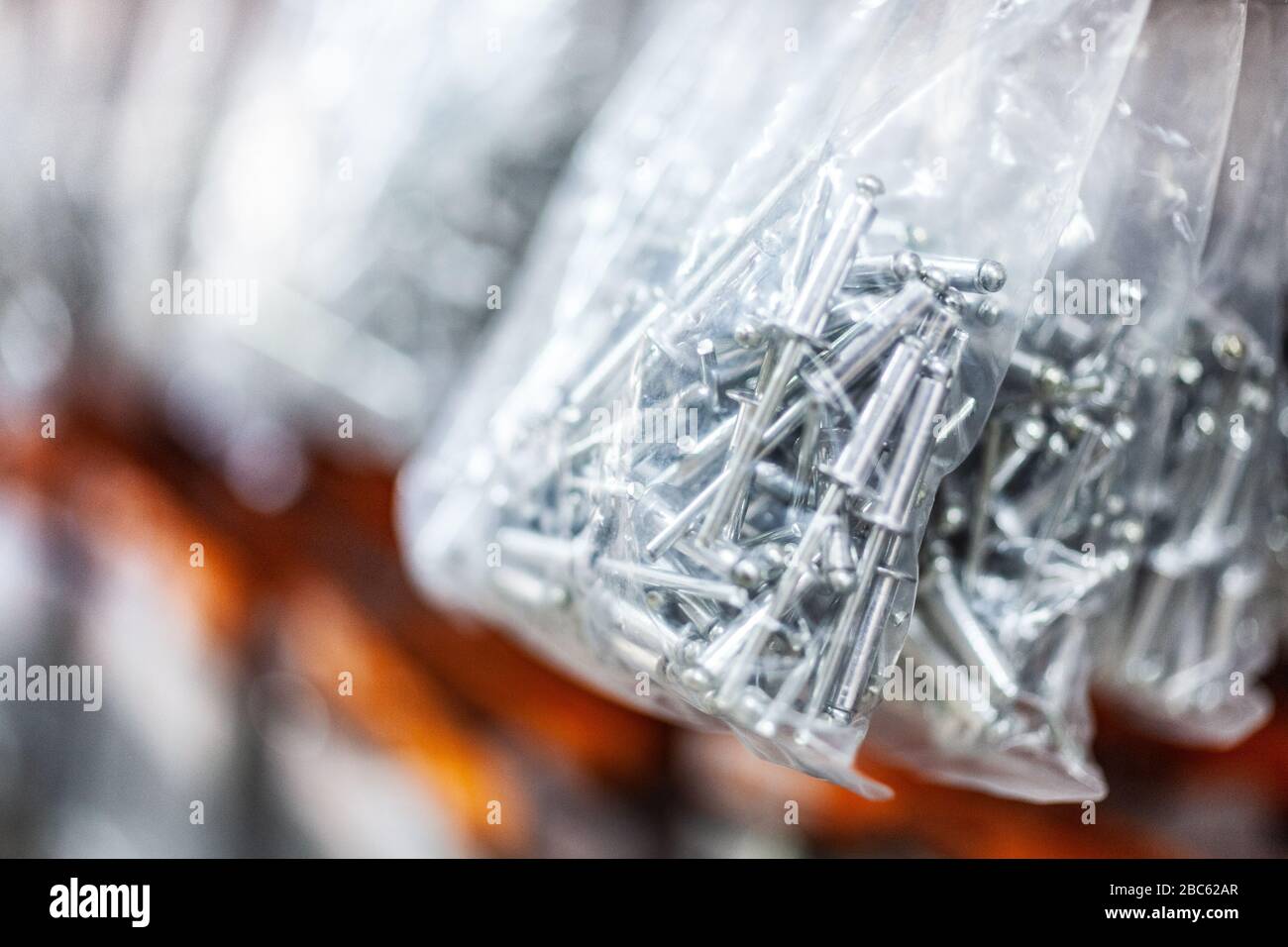 Bag of rivets in hardware store Stock Photo Alamy