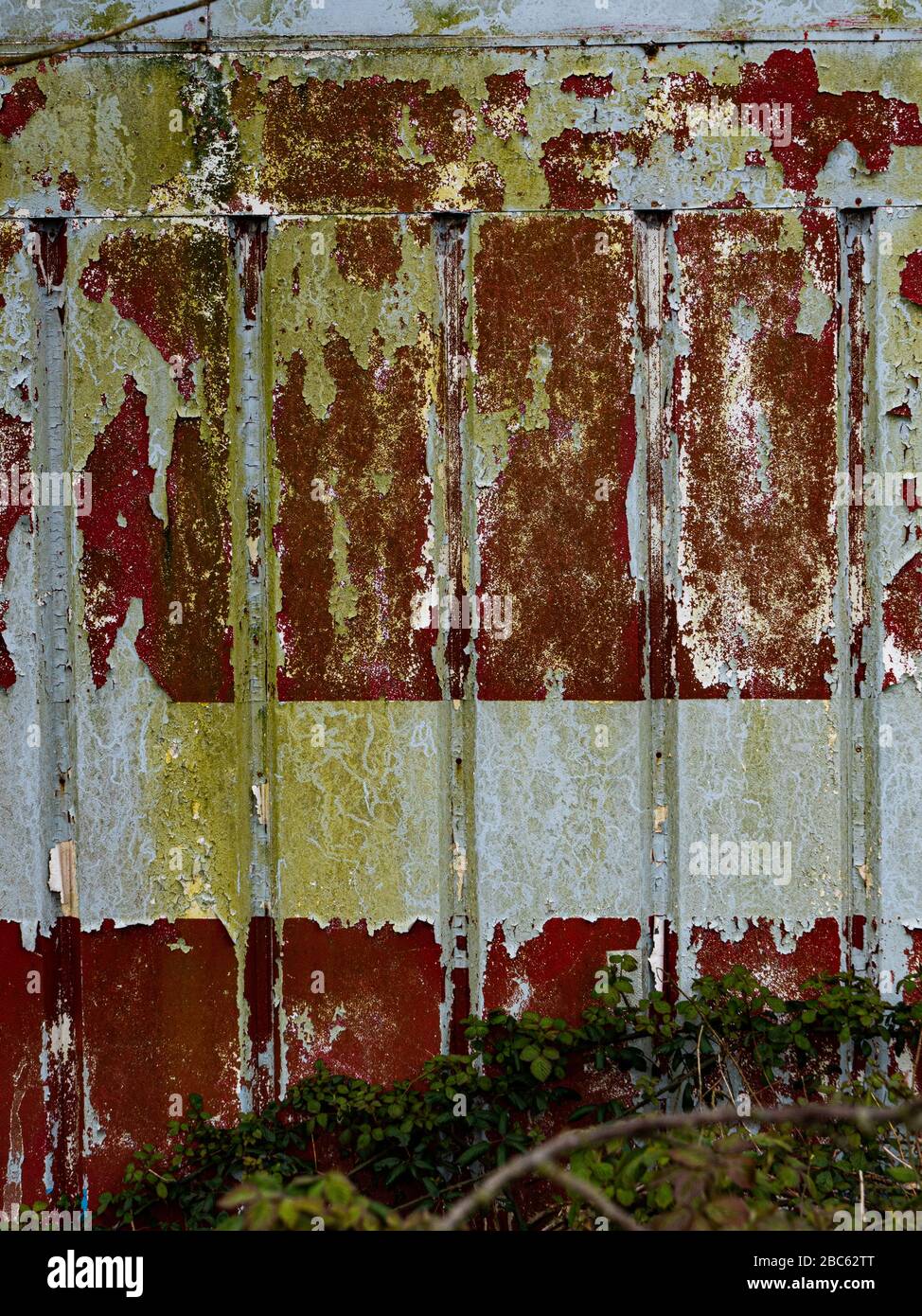 Background of rusty wall with peeling paint. Stock Photo