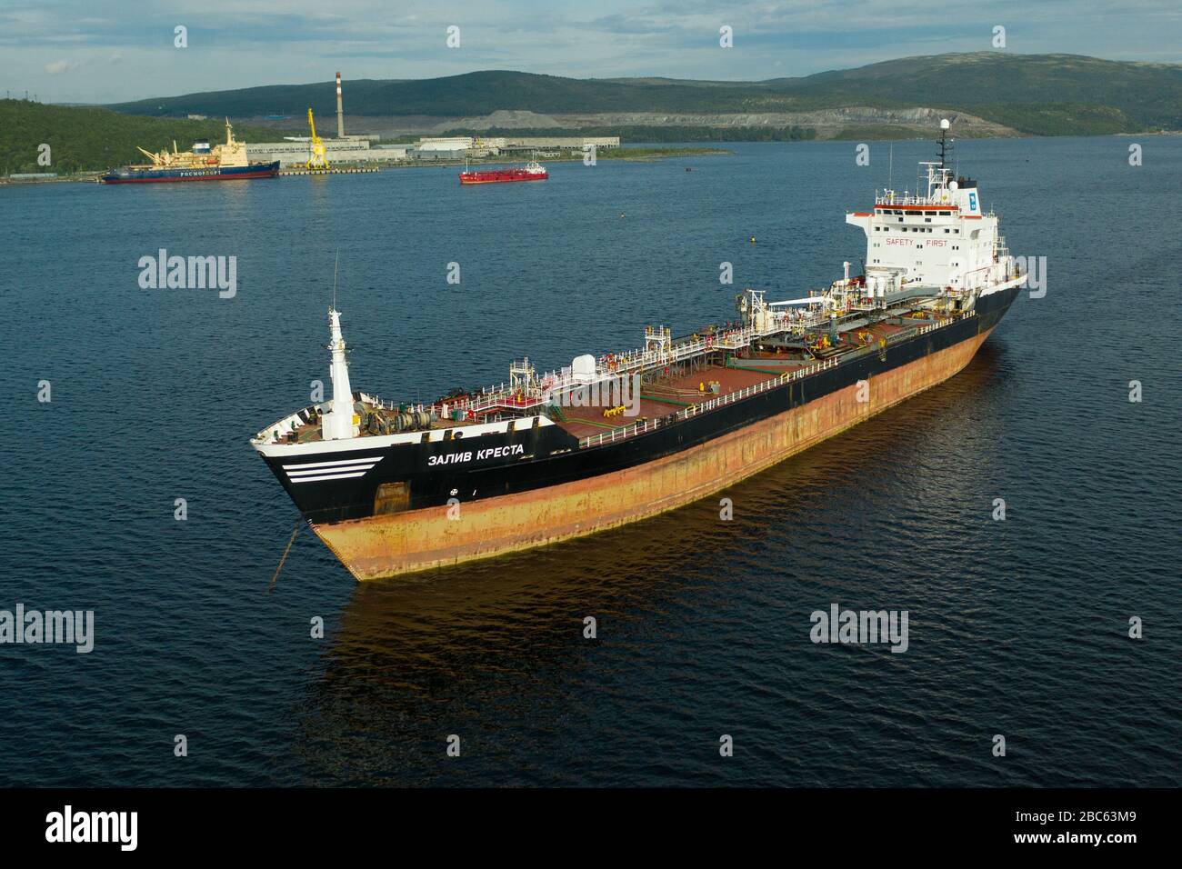Murmansk, Russia - August 18, 2019: The sea tanker Zaliv Kresta to be at a anchor on anchorage of the port Murmansk. Shooting from above drone. Stock Photo