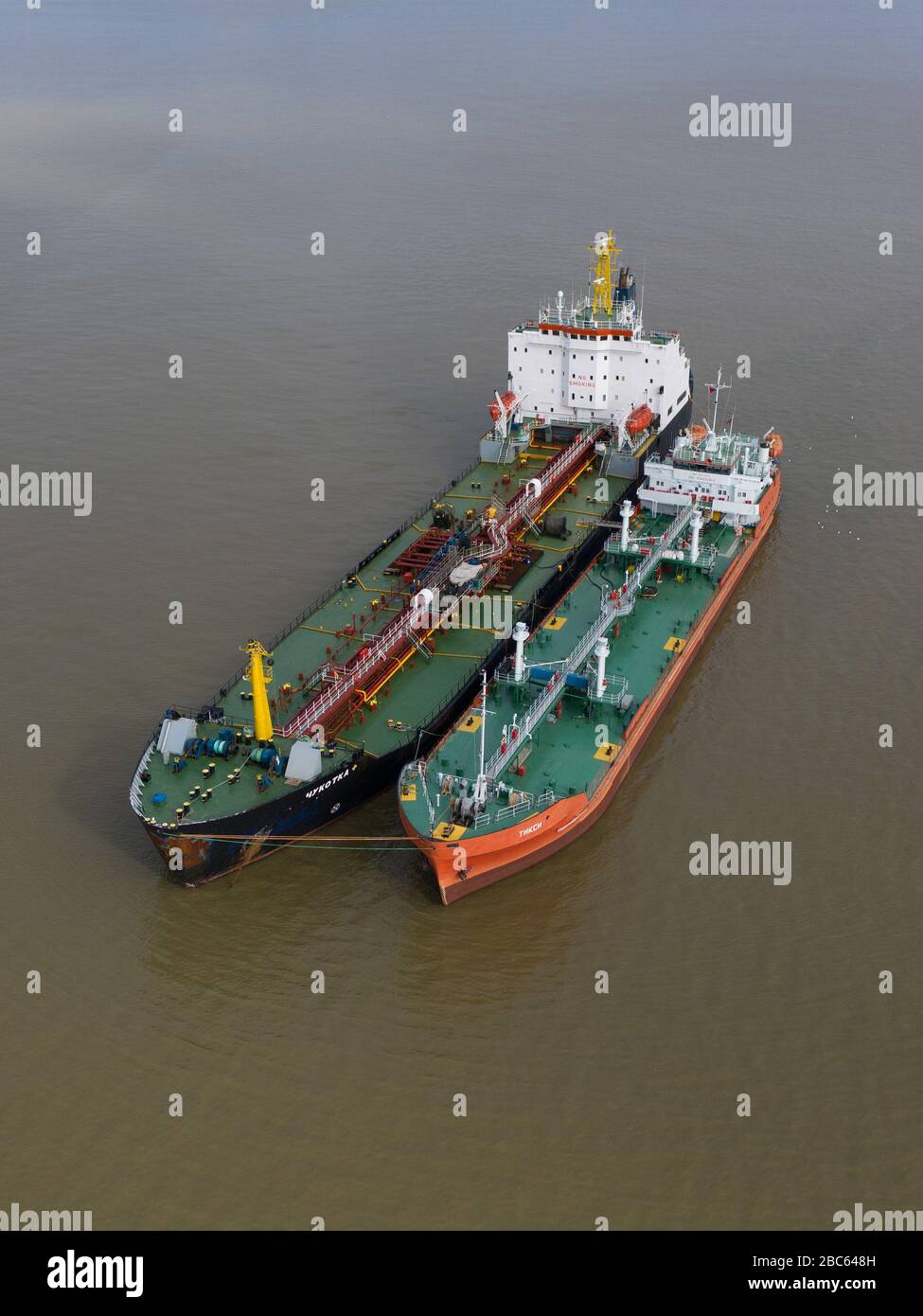 Ayon, Chukotski region, Russia - September 2, 2019: The top view on the Chukotka+ and Tiksi tankers on mooring. Shooting from above drone. Stock Photo