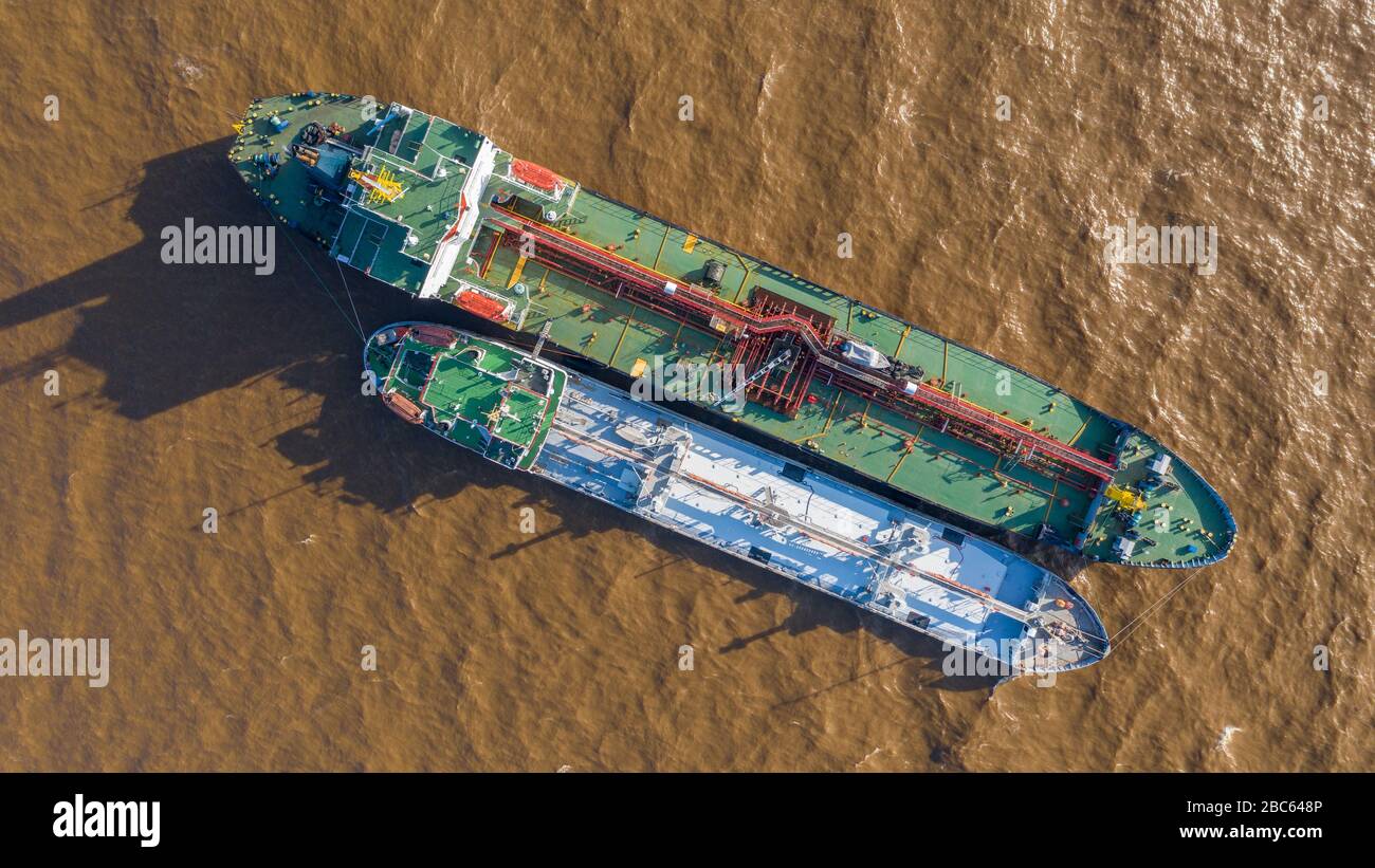 The tankers Chukotka + and Lenaneft 2033 are moored to each other, overload oil products. Stock Photo