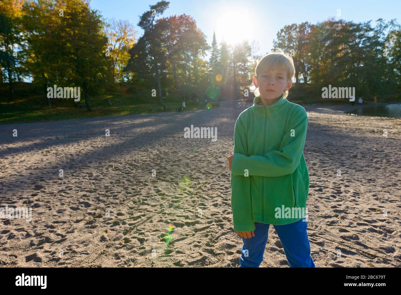 Young handsome boy near the lake at the park Stock Photo