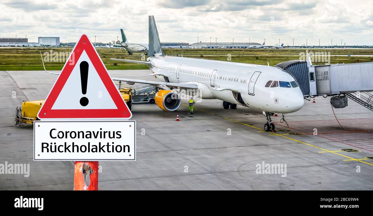 Corona virus return action warning sign with airplane in german Stock Photo