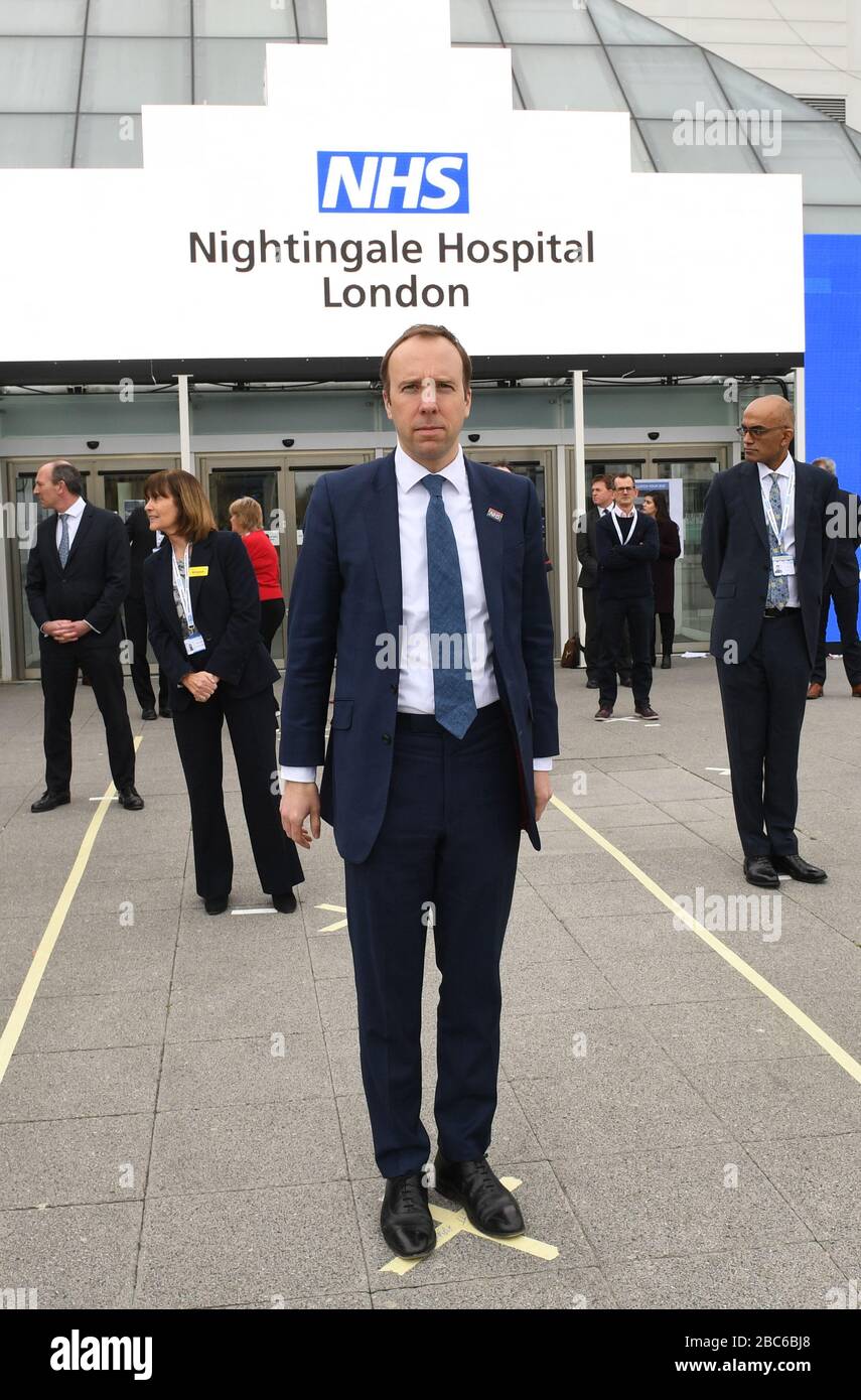 Health Secretary Matt Hancock and NHS staff stands on a mark on the ground, put in place to ensure social distancing guidelines are adhered to, at the opening of the NHS Nightingale Hospital at the ExCel centre in London, a temporary hospital with 4000 beds which has been set up for the treatment of Covid-19 patients. Stock Photo
