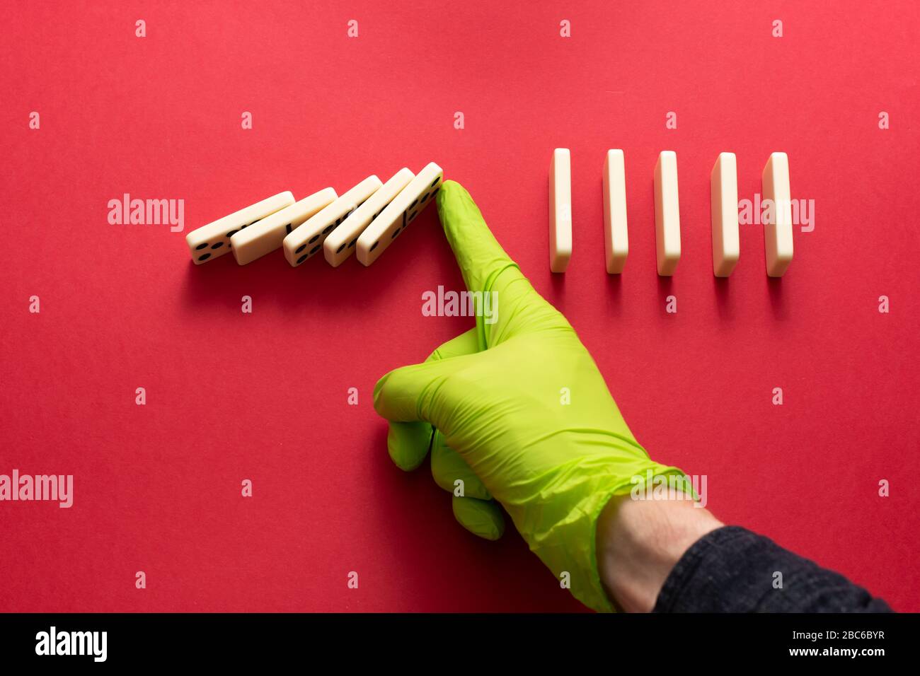 Physical distancing. Avoiding close contact is the key to slowing coronavirus Covid-19. Social distancing concept. Domino effect. Stock Photo