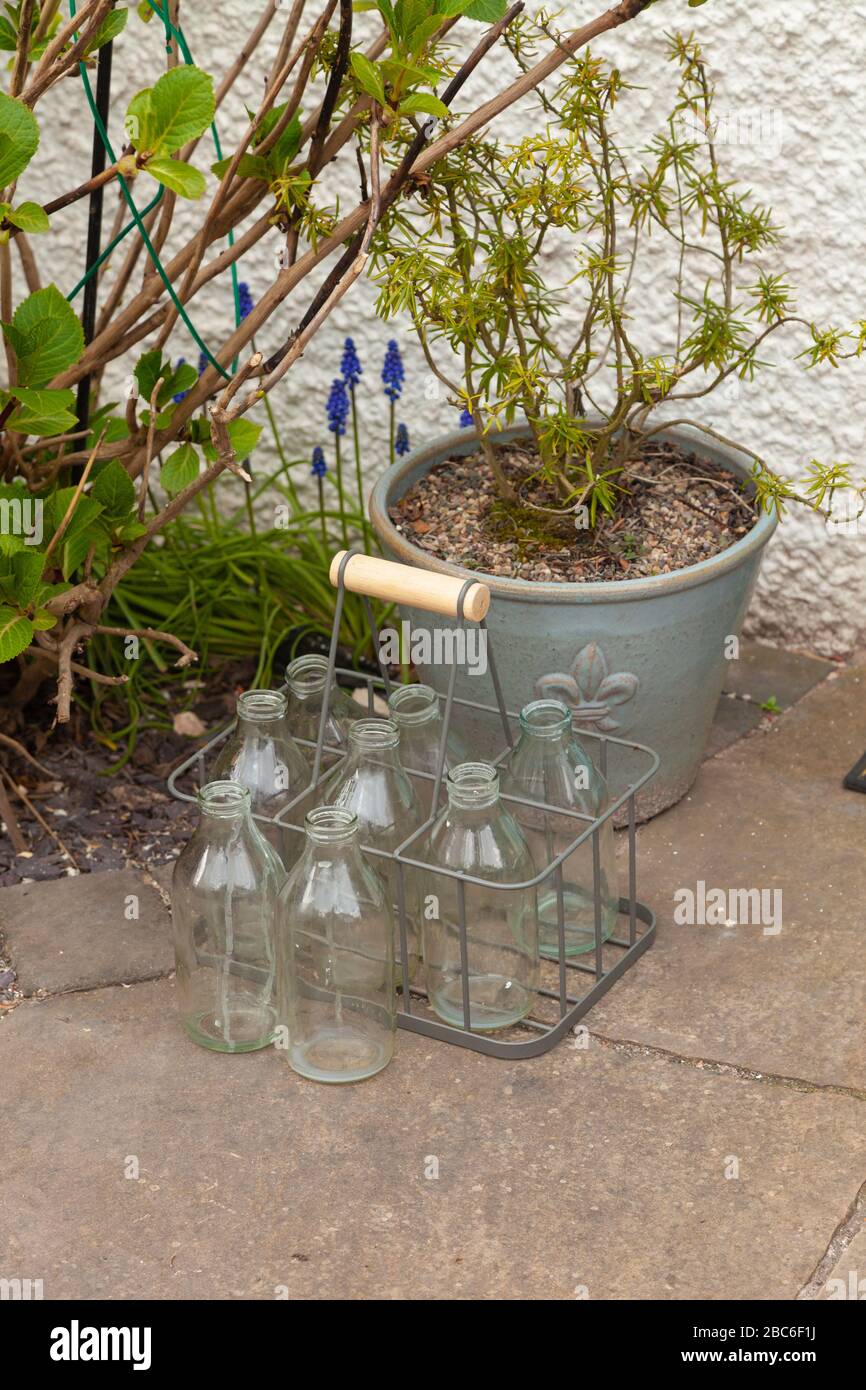 Empty milk bottles on a doorstep. Stock Photo