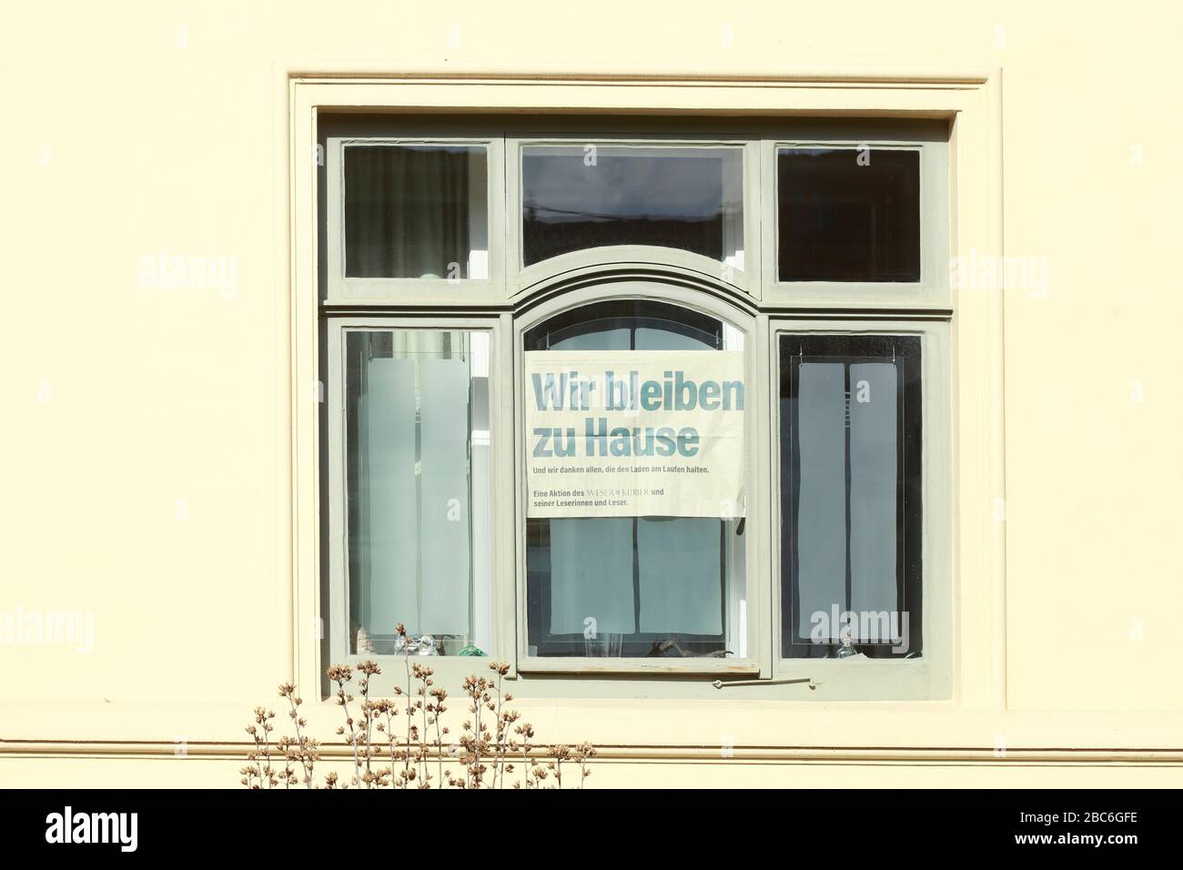 Window with sign We stay at home because of corona, Bremen, Germany, Europe Stock Photo