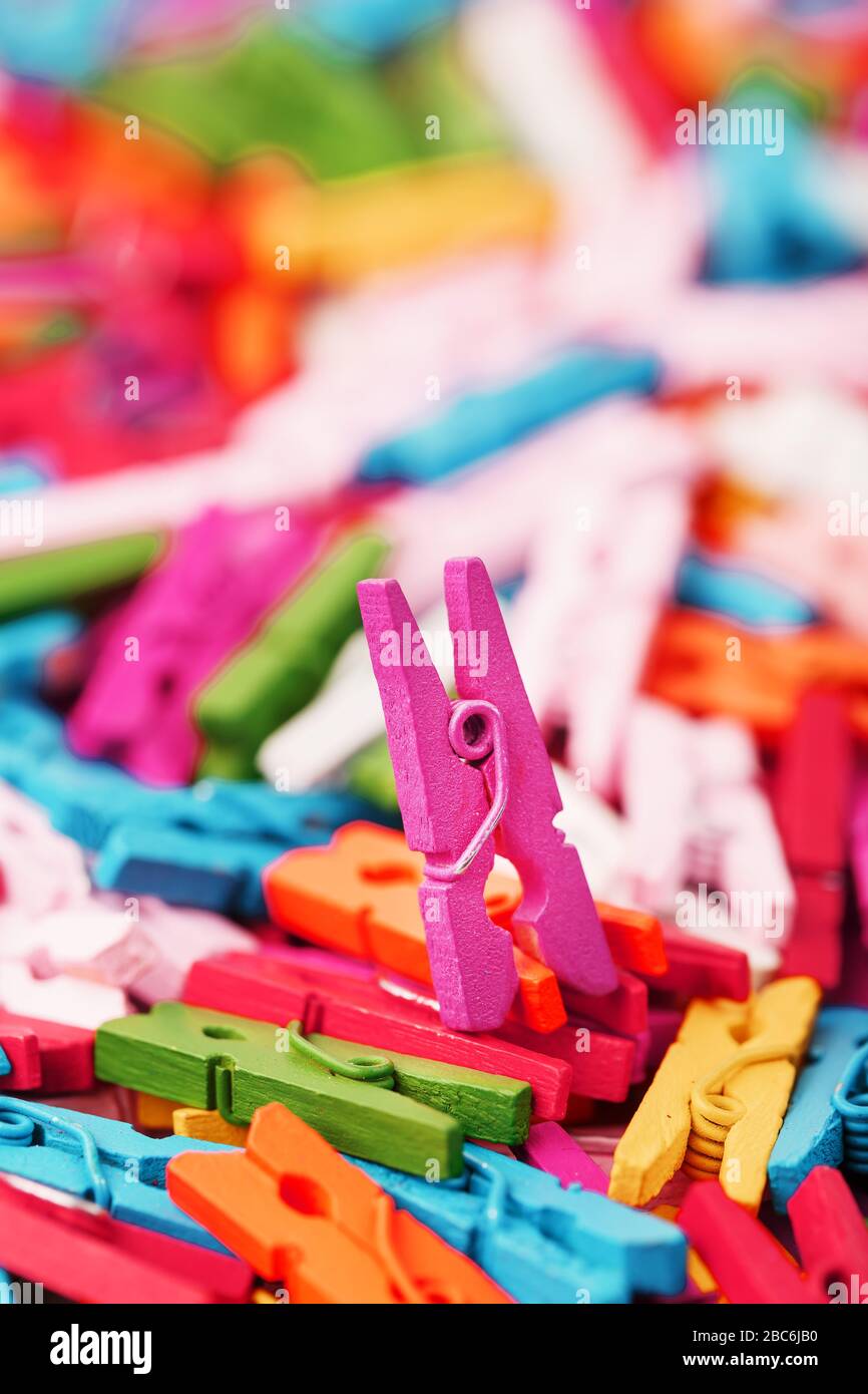Small Clothespins of different colors closeup as a texture and