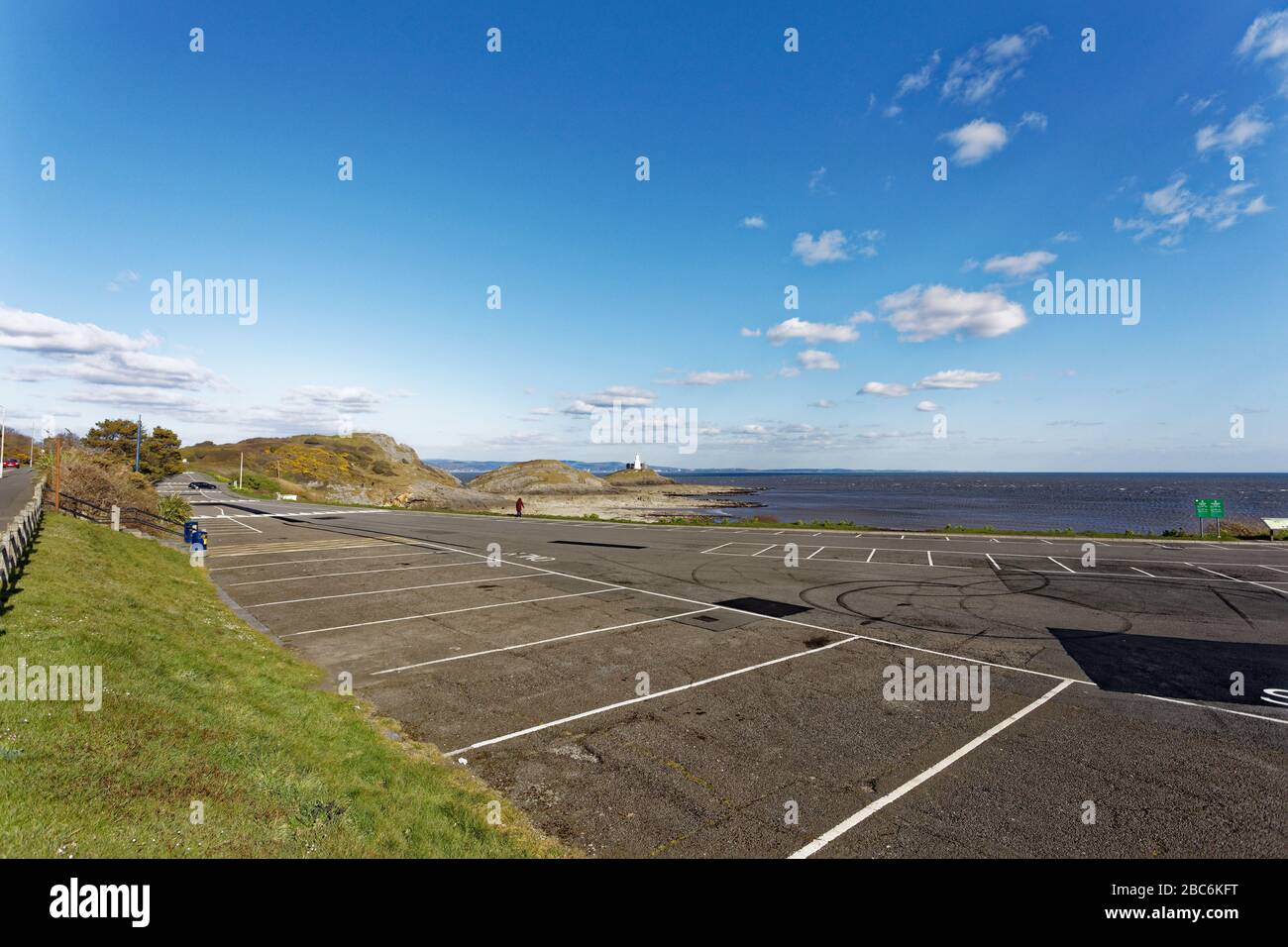 Pictured: The car park in Bracelet Bay, which is usually busy with people on Sunday afternoon when it is sunny, is now deserted in Swansea, Wales, UK. Stock Photo