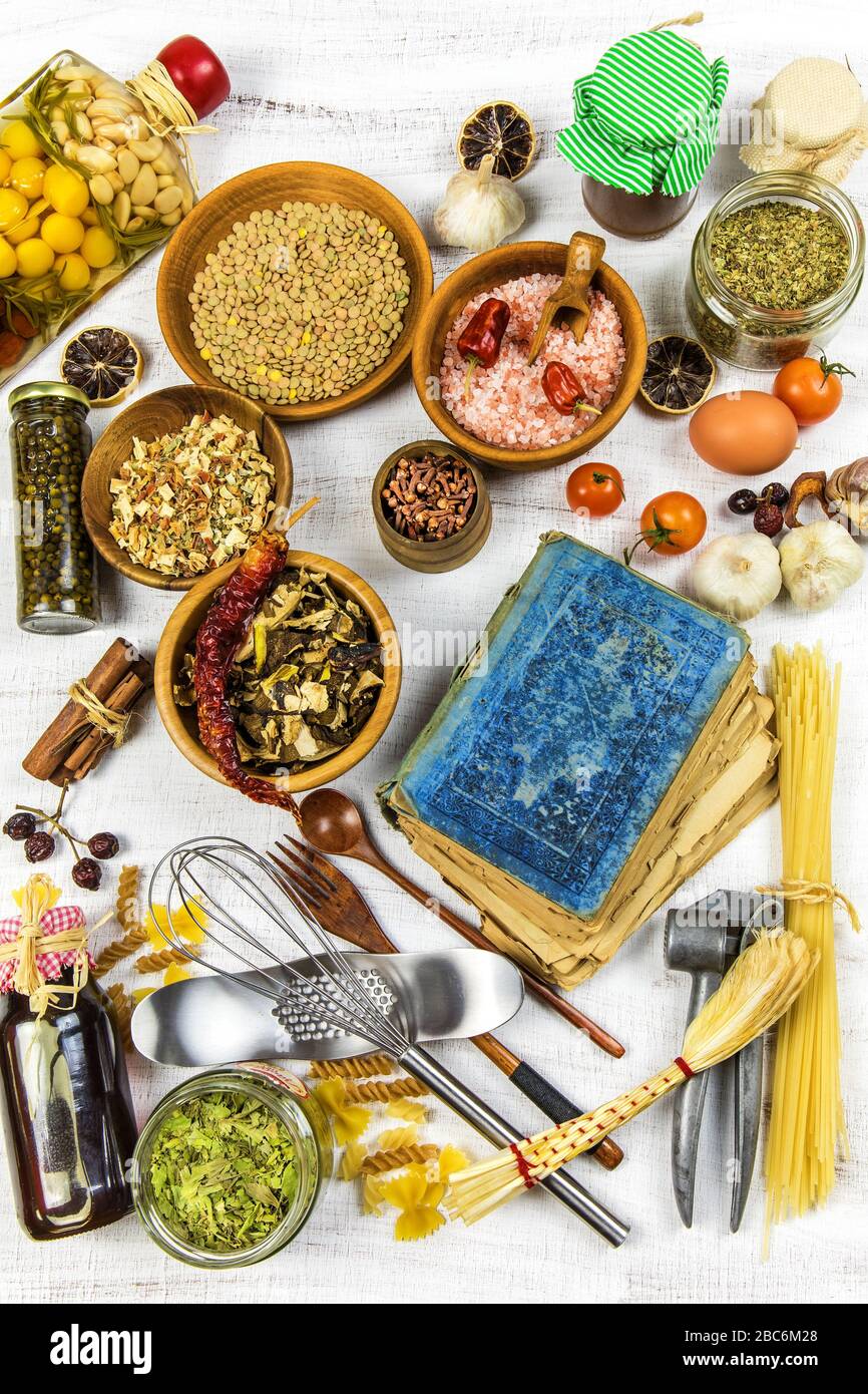 https://c8.alamy.com/comp/2BC6M28/herbs-and-spices-with-a-recipe-book-on-white-wooden-background-blank-cookbook-and-variuos-spices-and-herbs-top-view-2BC6M28.jpg