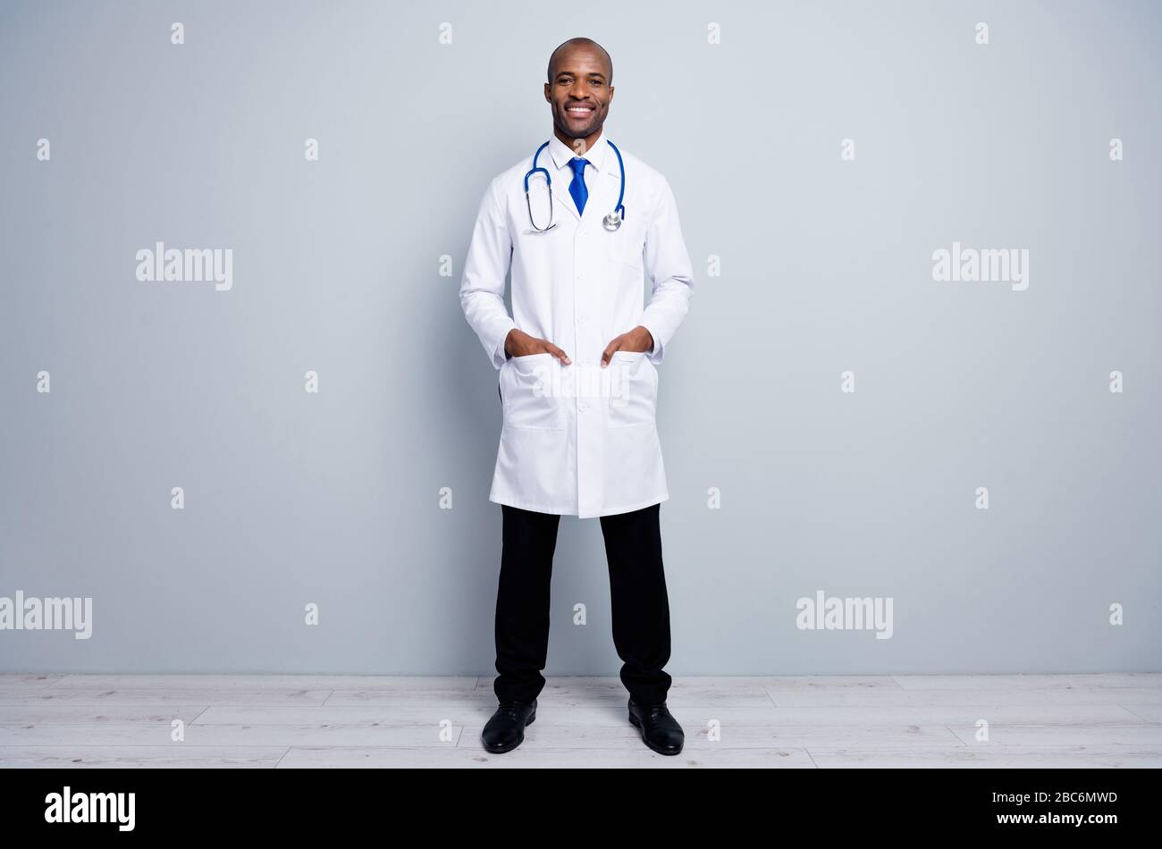 Full length photo of doctor intern dark skin guy good mood friendly smiling to patients virologist search disease test people wear white lab coat neck Stock Photo Alamy