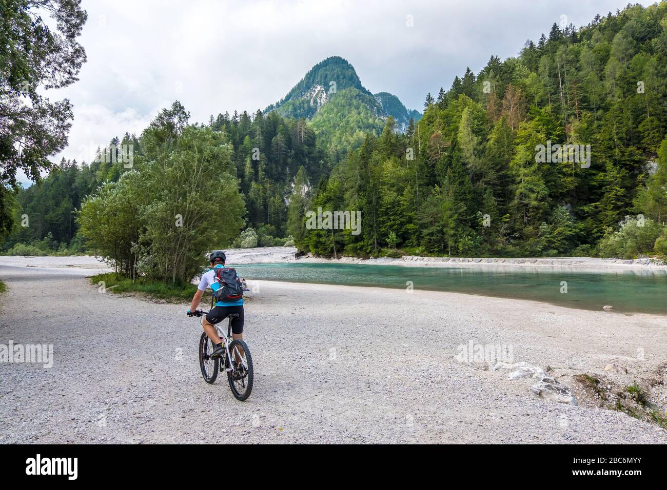 Triglav, Slovenia - August 11, 2019: Tourist on a bicycle on the river bank in Triglav national park. Julian Alps, Triglav, Slovenia Stock Photo