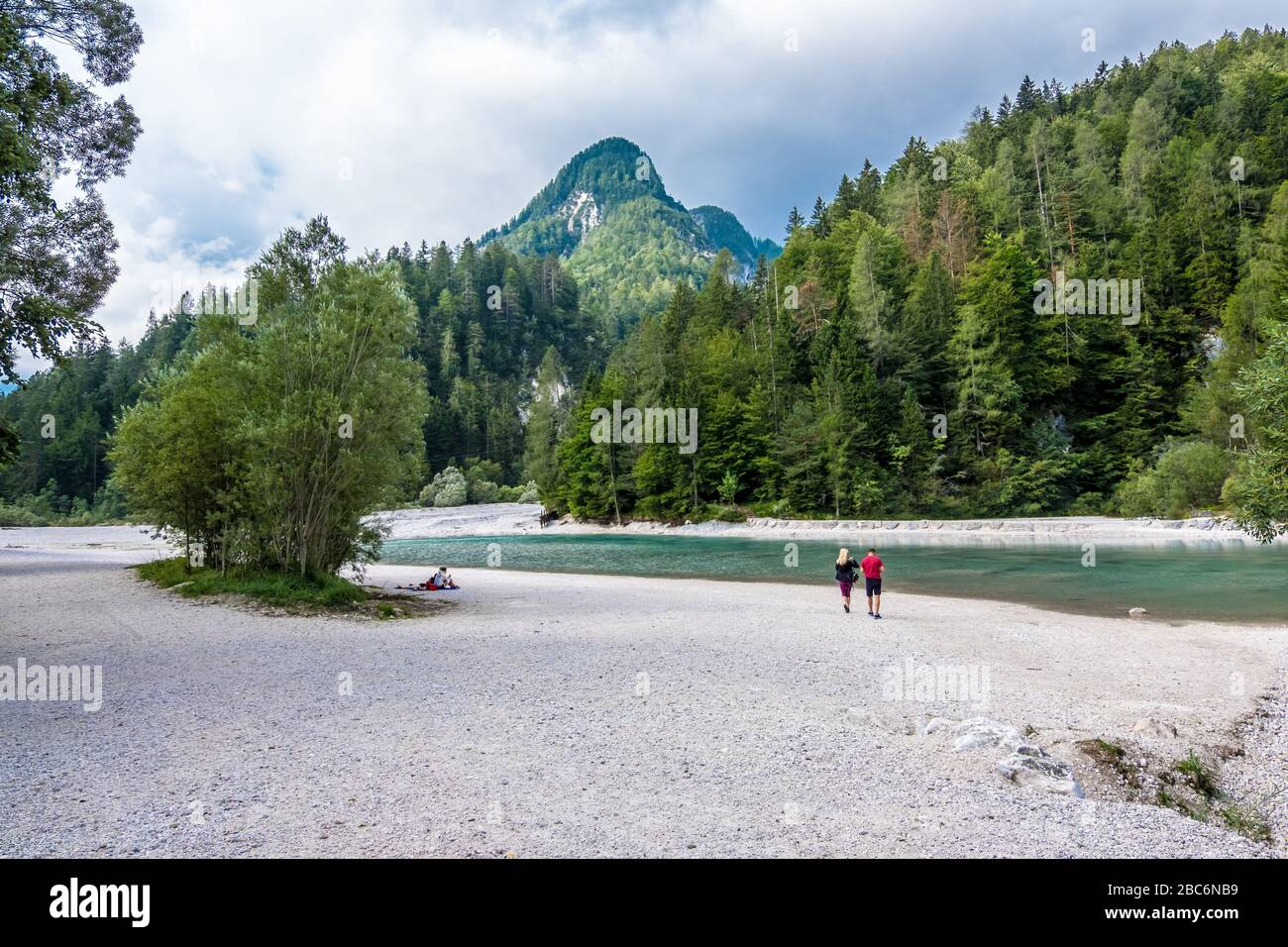 Triglav, Slovenia - August 11, 2019: Hikers have a rest on the river bank in Triglav national park. Julian Alps, Triglav, Slovenia Stock Photo