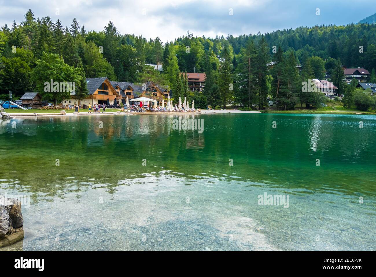 Triglav, Slovenia - August 11, 2019: Hikers have a rest at Lake in Triglav national park. Julian Alps, Triglav, Slovenia Stock Photo