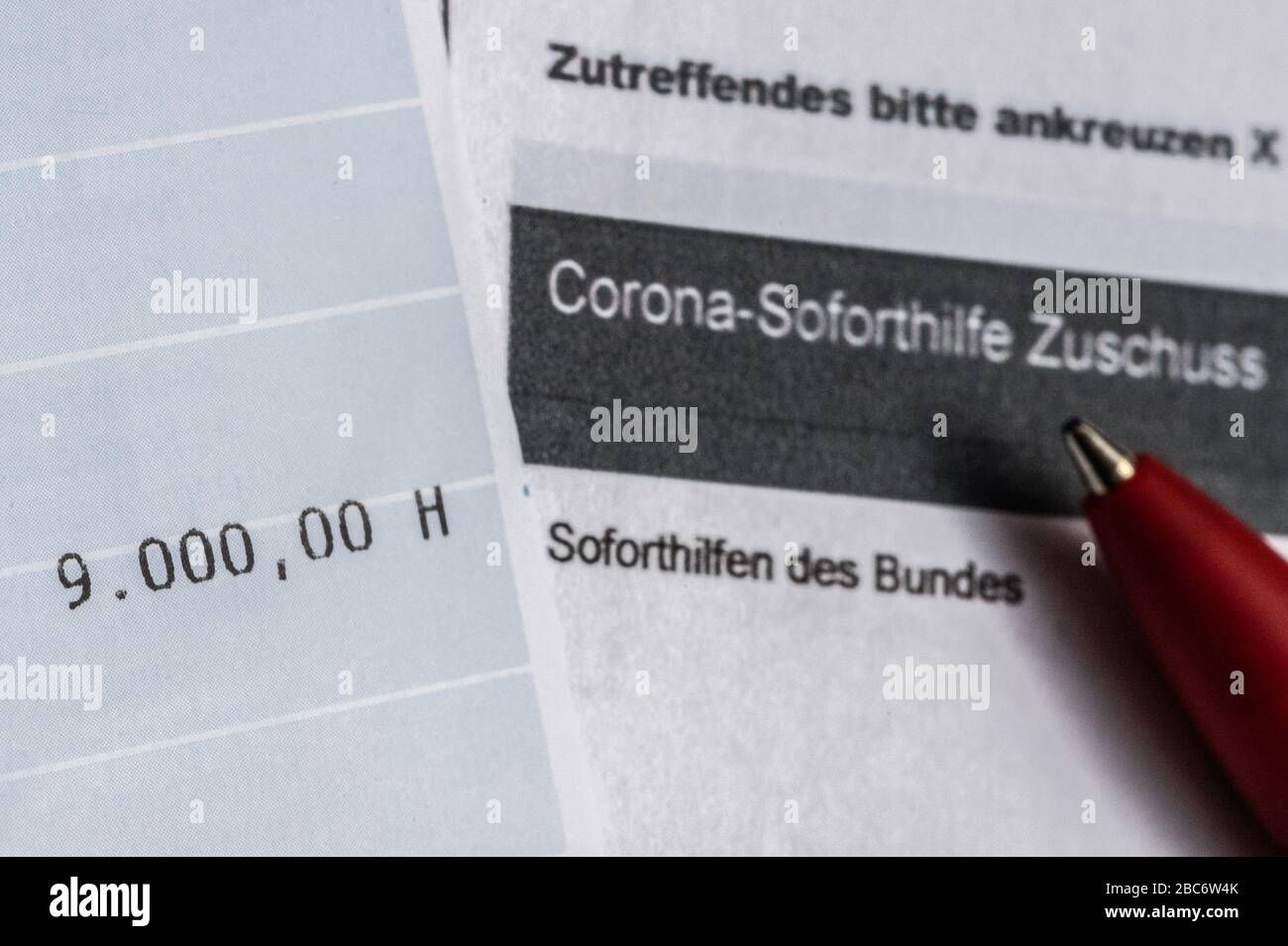 03 April 2020 Saxony Dresden Illustration A Bank Statement With The Transferred Sum Of 9 000 Euros Of Corona Emergency Aid Is On An Application For A Grant From The Sachsische Aufbaubank To