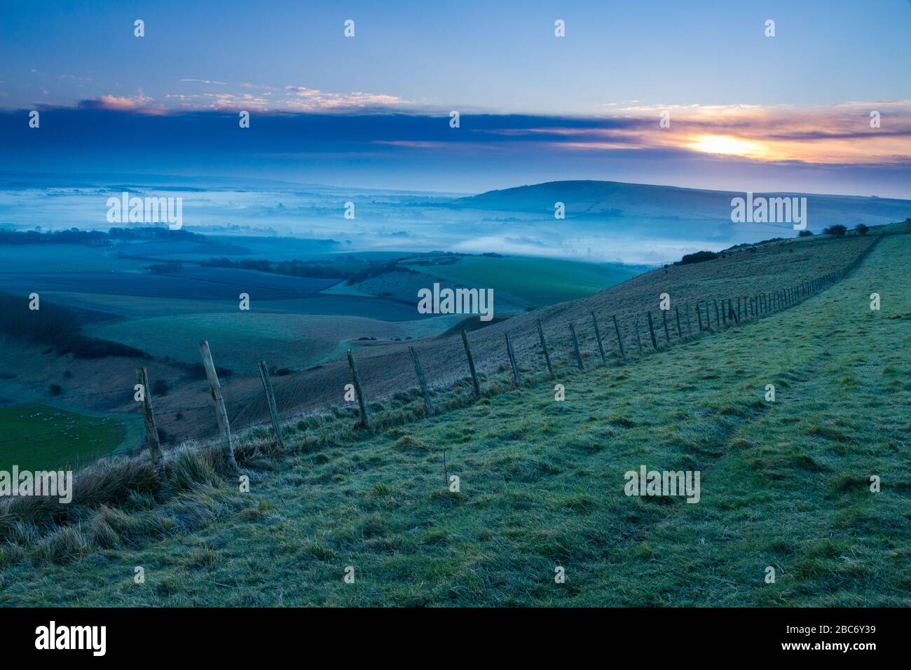 Misty morning sunrise over the south downs in east sussex England from Bo Peep Stock Photo