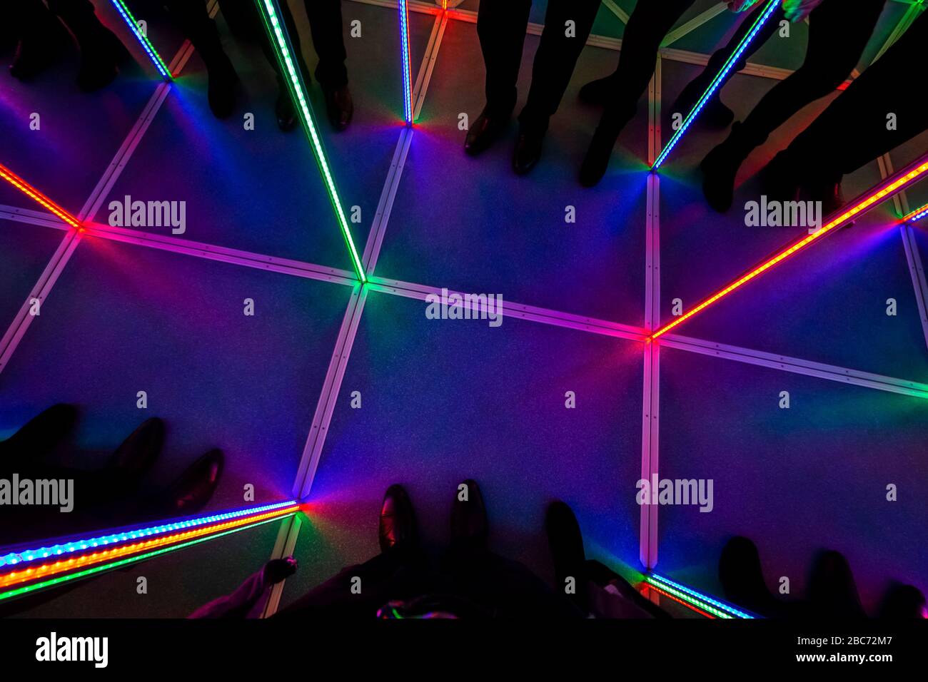 Inside the attraction "Mirror Maze" with LED multi-colored backlight. Stock Photo
