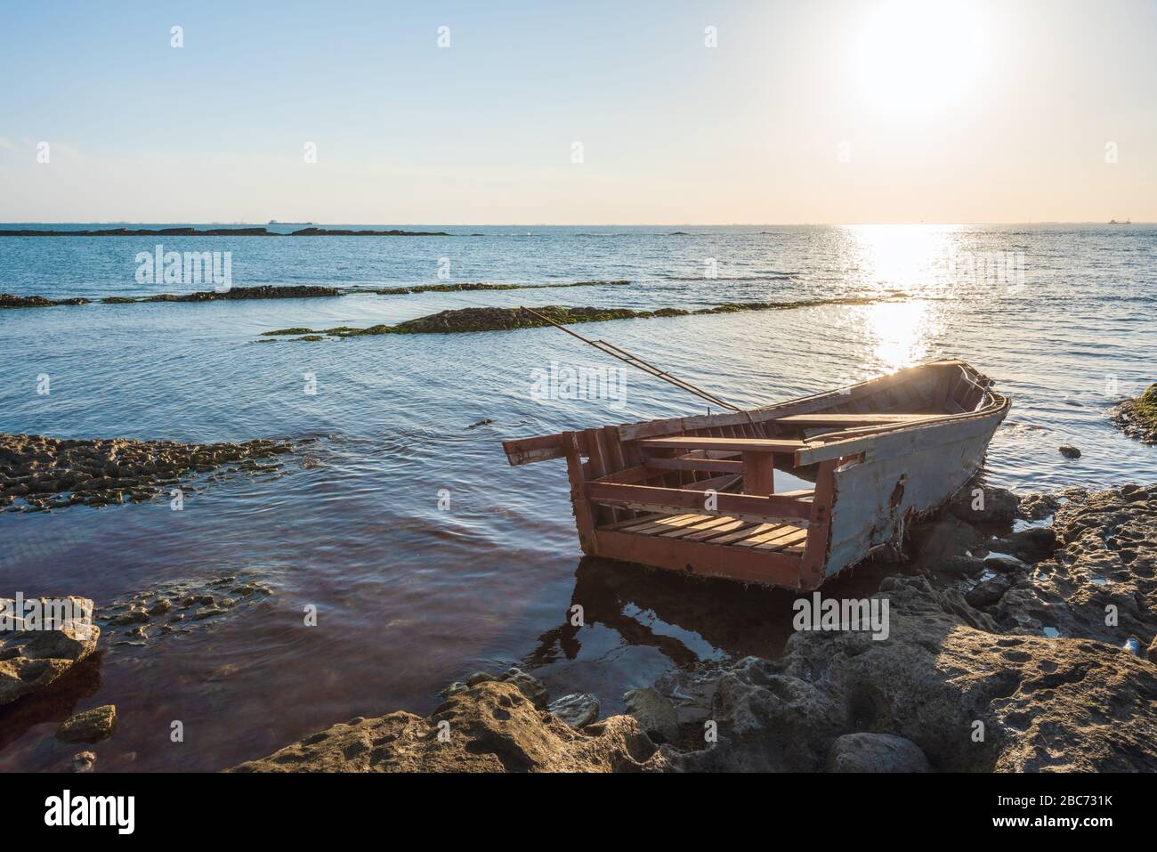 Old broken fishing boat on the shore Stock Photo - Alamy