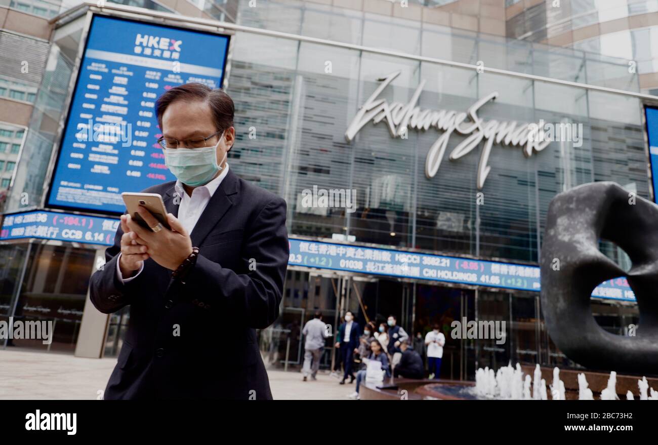 Hong Kong China 3rd Apr 2020 Masked Businessman Checking His Smartphone Outside Exchange Square The Core Financial Location In Central Global Coronavirus Infections Introduced By China Pneumonia Have Reached 1 Million Mark