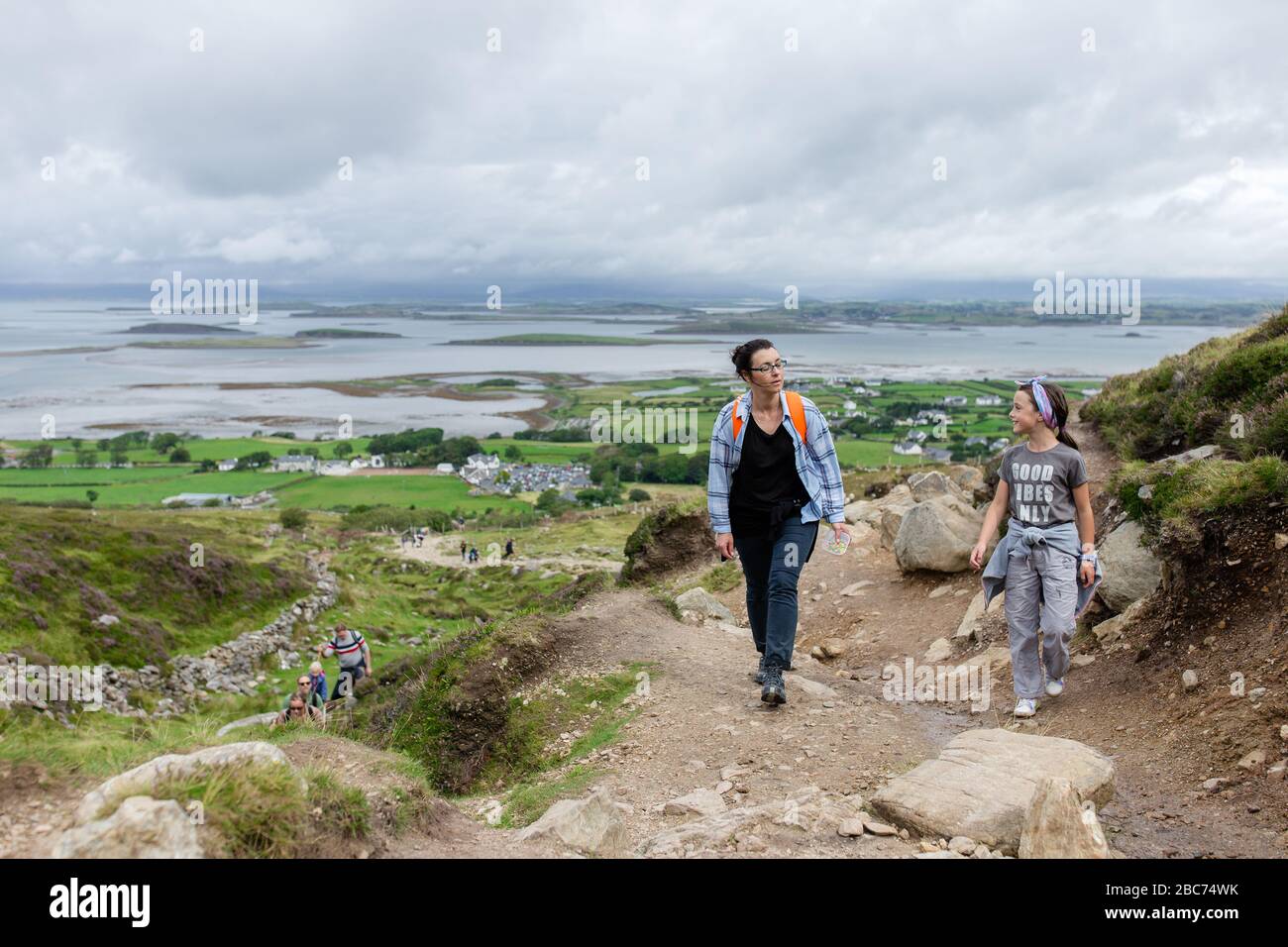 Mother and daughter on a hiking trail, climbing Croagh Patrick mountain in Westport, Co.Mayo, Ireland Stock Photo