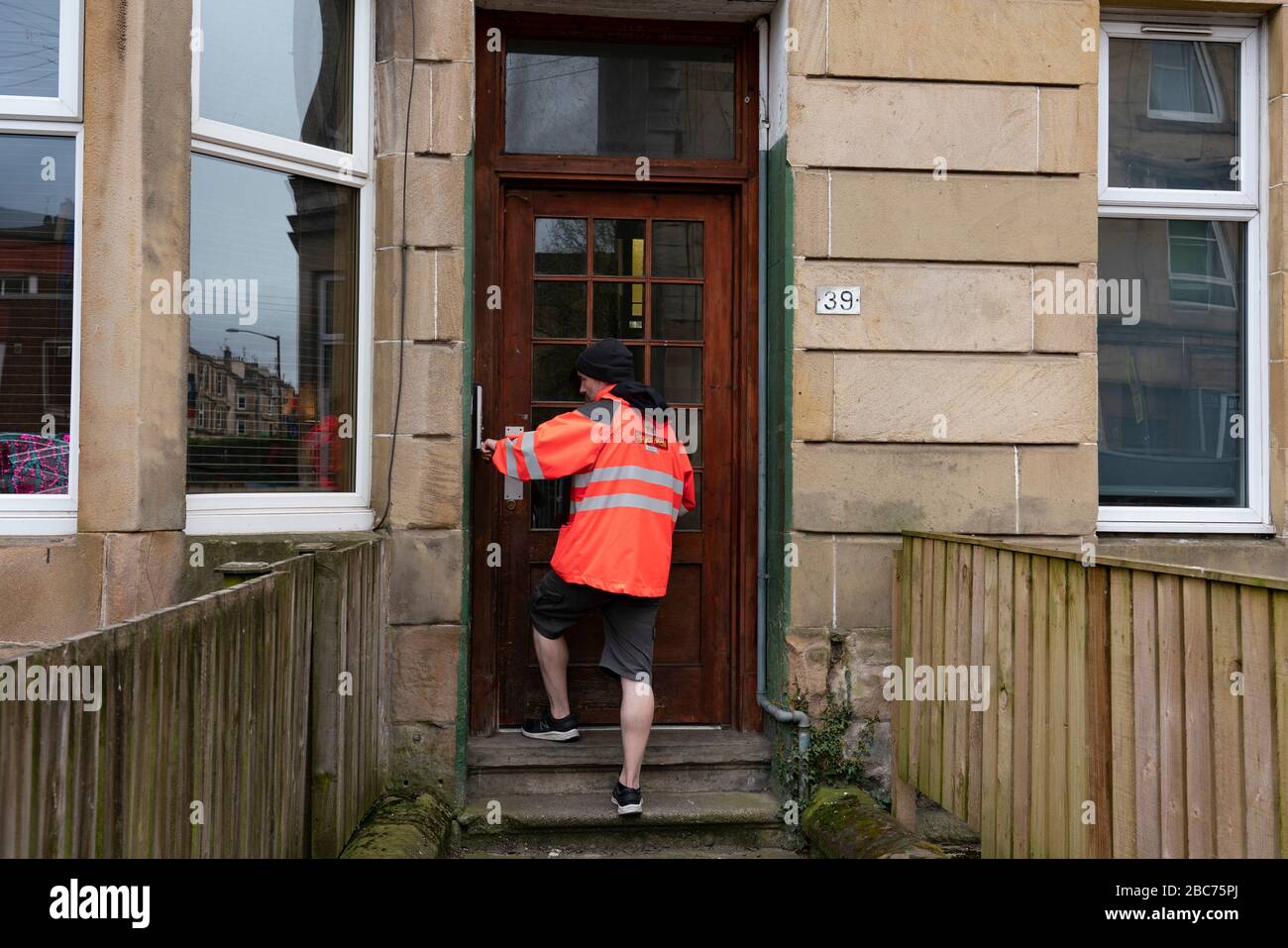 Glasgow, Scotland, UK. 3 April, 2020. Images from the southside of Glasgow at the end of the second week of Coronavirus lockdown. Pictured; Royal Mail postman making deliveries in Shawlands. Iain Masterton/Alamy Live News Stock Photo