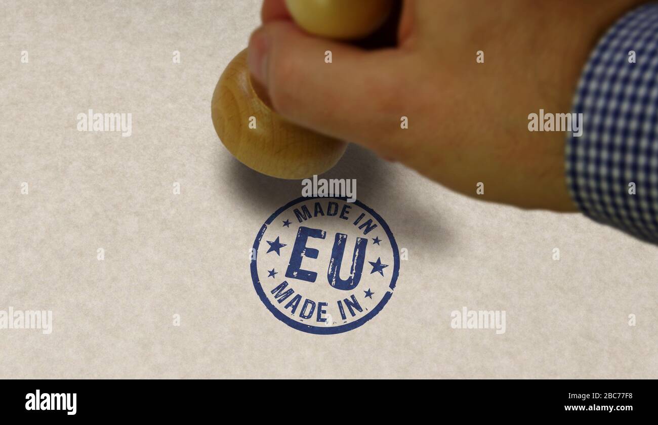 Made in EU, Europe, European Union stamp and stamping hand. Factory, manufacturing and production country concept. Stock Photo