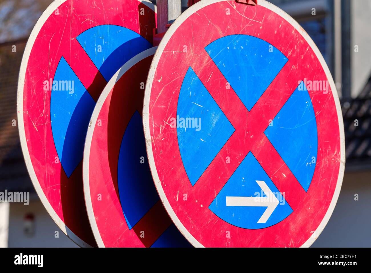 Three traffic signs with absolute no stopping restriction standing in a row on a construction site in front of a house. Seen in Germany in April. Stock Photo
