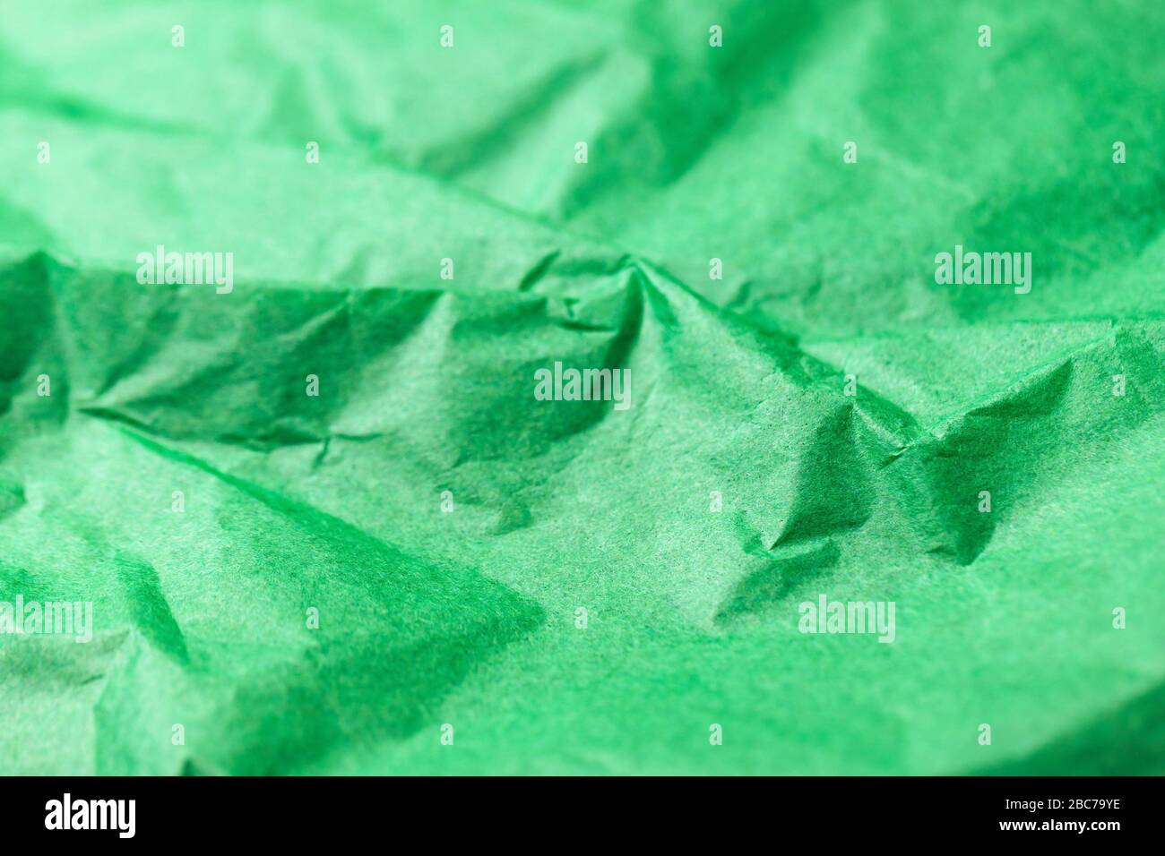 Crumpled vivid green paper texture abstract background Stock Photo