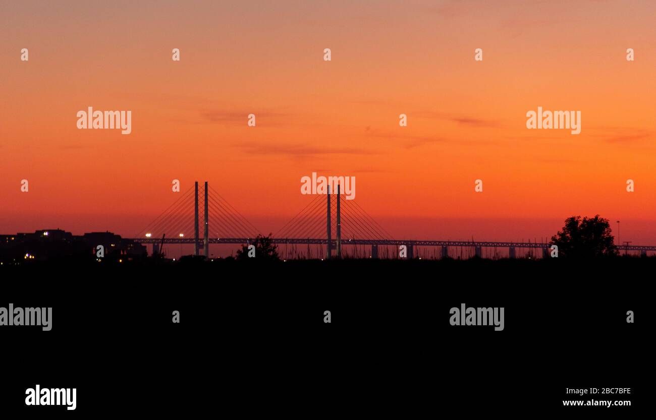 The Öresund bridge sunset silhouette during warm summer evening. Stock Photo