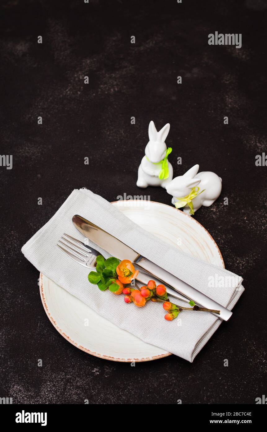 Easter table setting with spring flowering branches, cutlery and ...