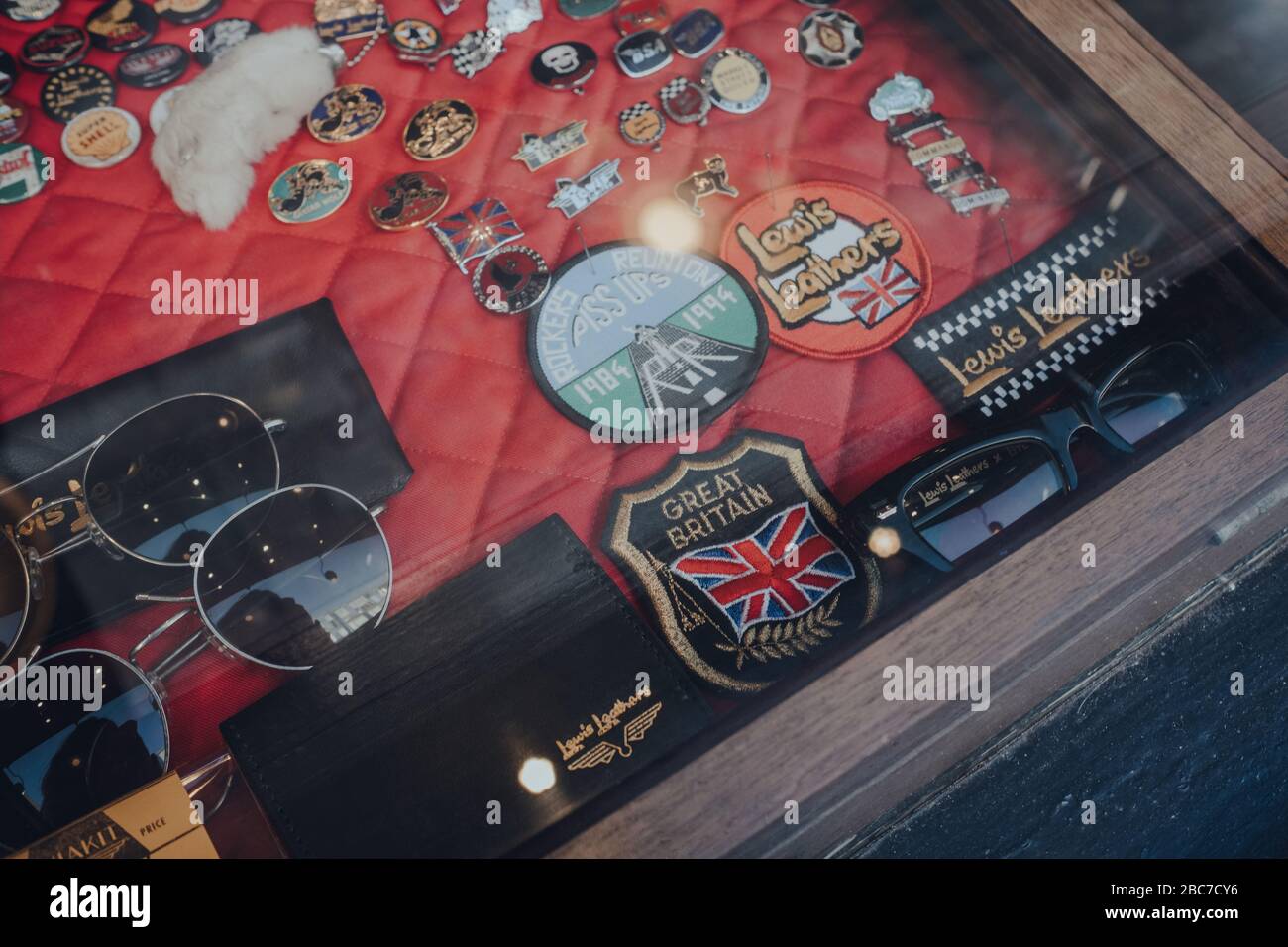 London, UK - March 06, 2020: Glasses, accessories and badges at a window retail display of Lewis Leather, famous shop selling biker jackets, gloves an Stock Photo