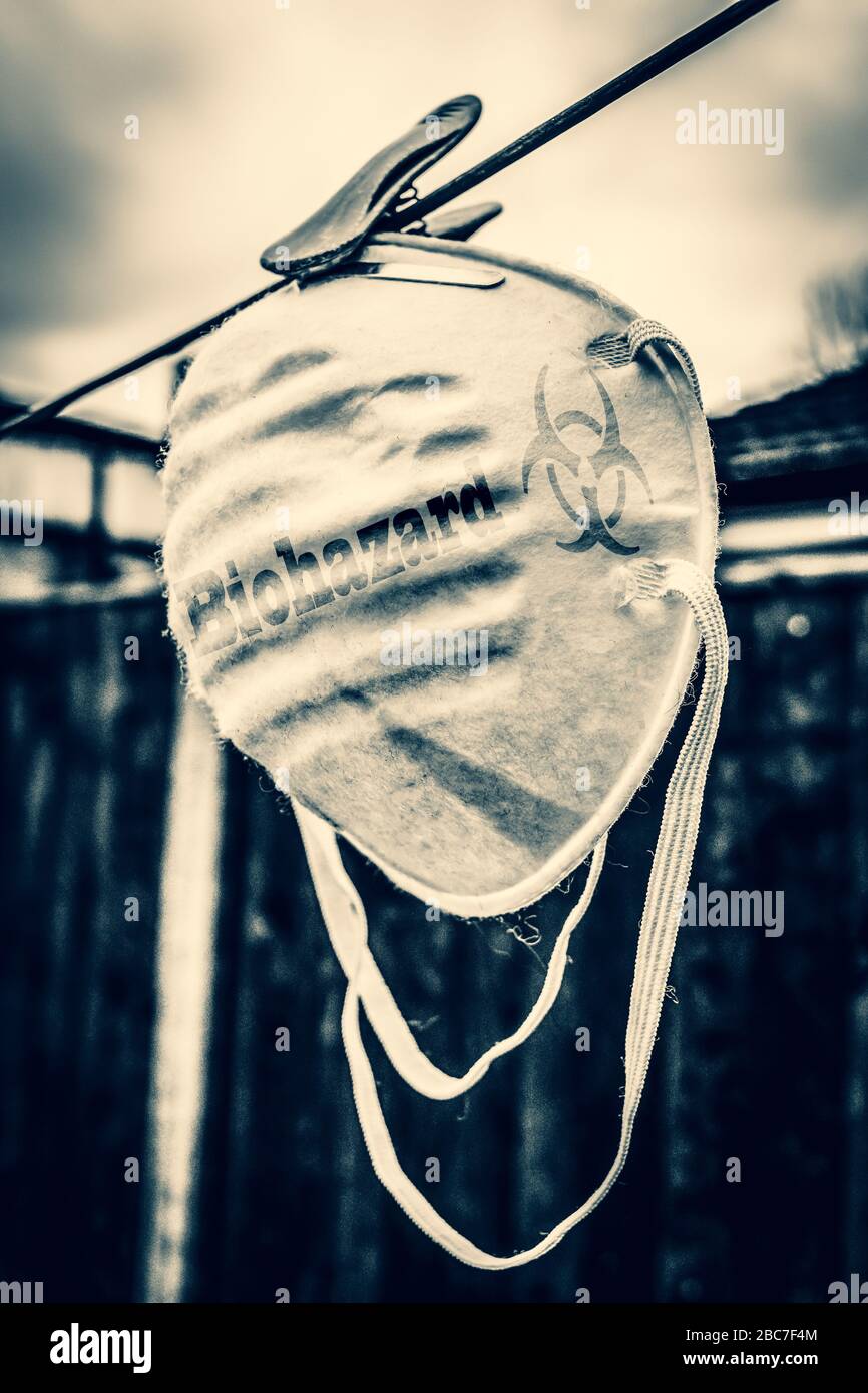 Face protection mask hanging on washing line Stock Photo Alamy