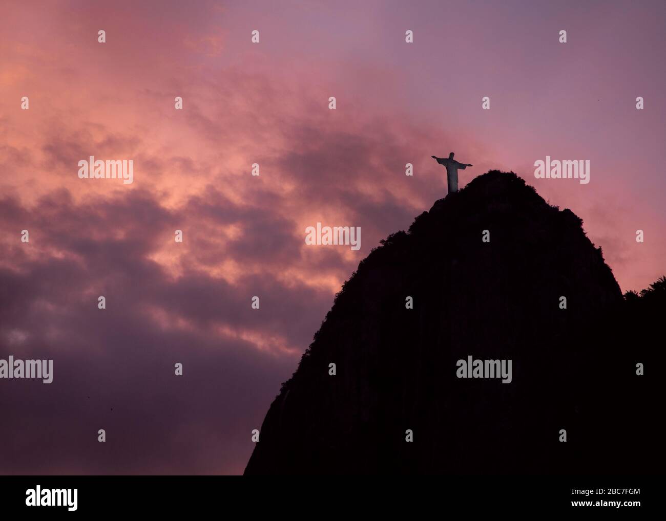 Silhouette of Christ The Redeemer against the Purple dusk sky Stock Photo