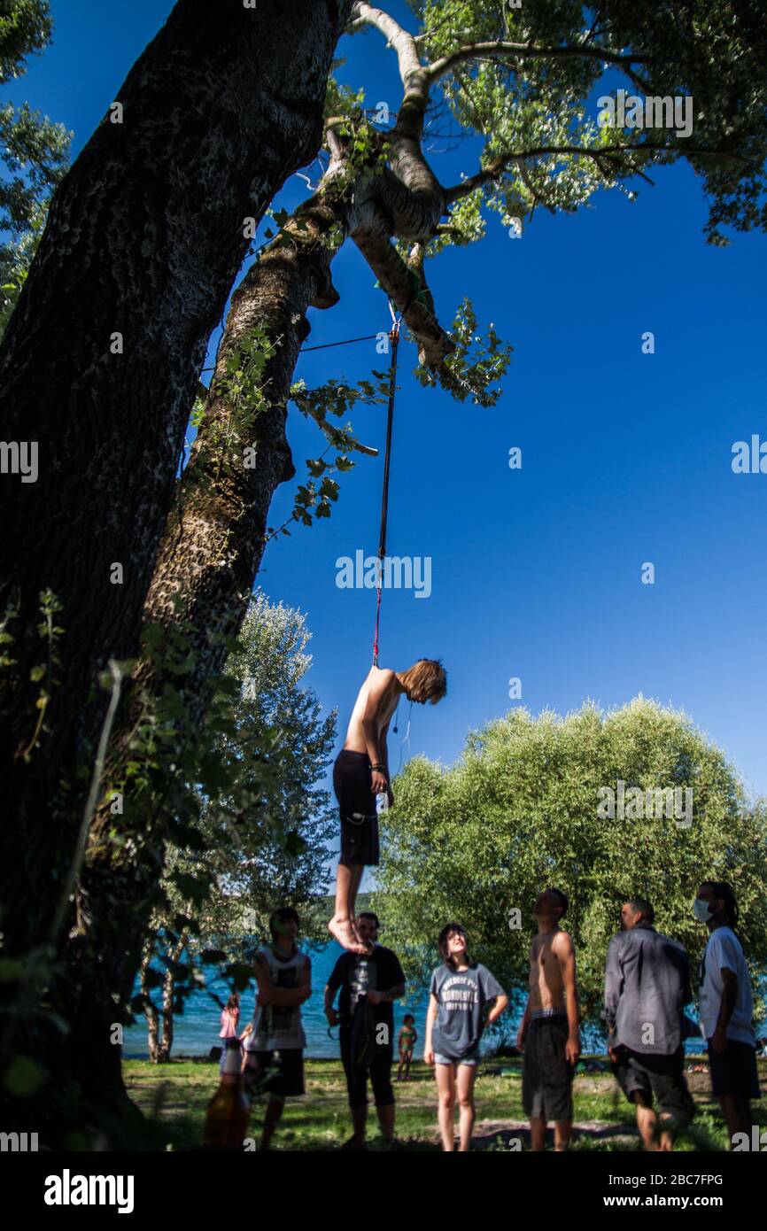 body piercing hanging at the lake Stock Photo - Alamy