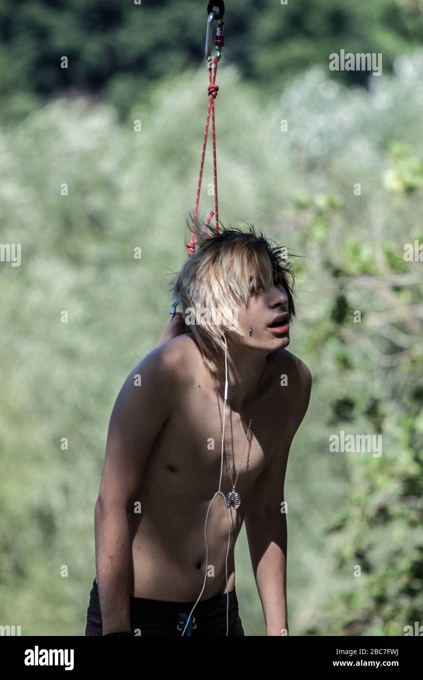 body piercing hanging at the lake Stock Photo - Alamy