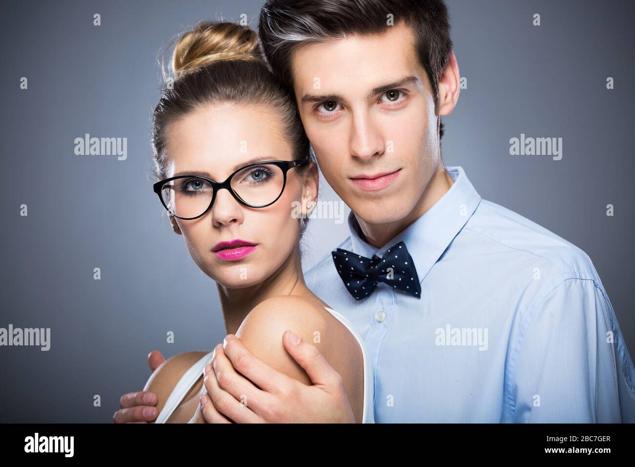 Young couple standing over grey background Stock Photo