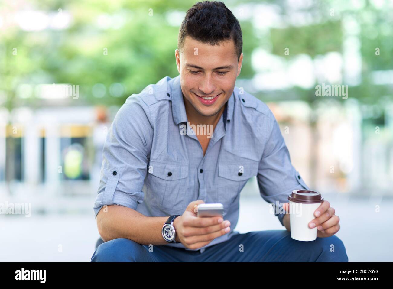 Young man using his smartphone Stock Photo