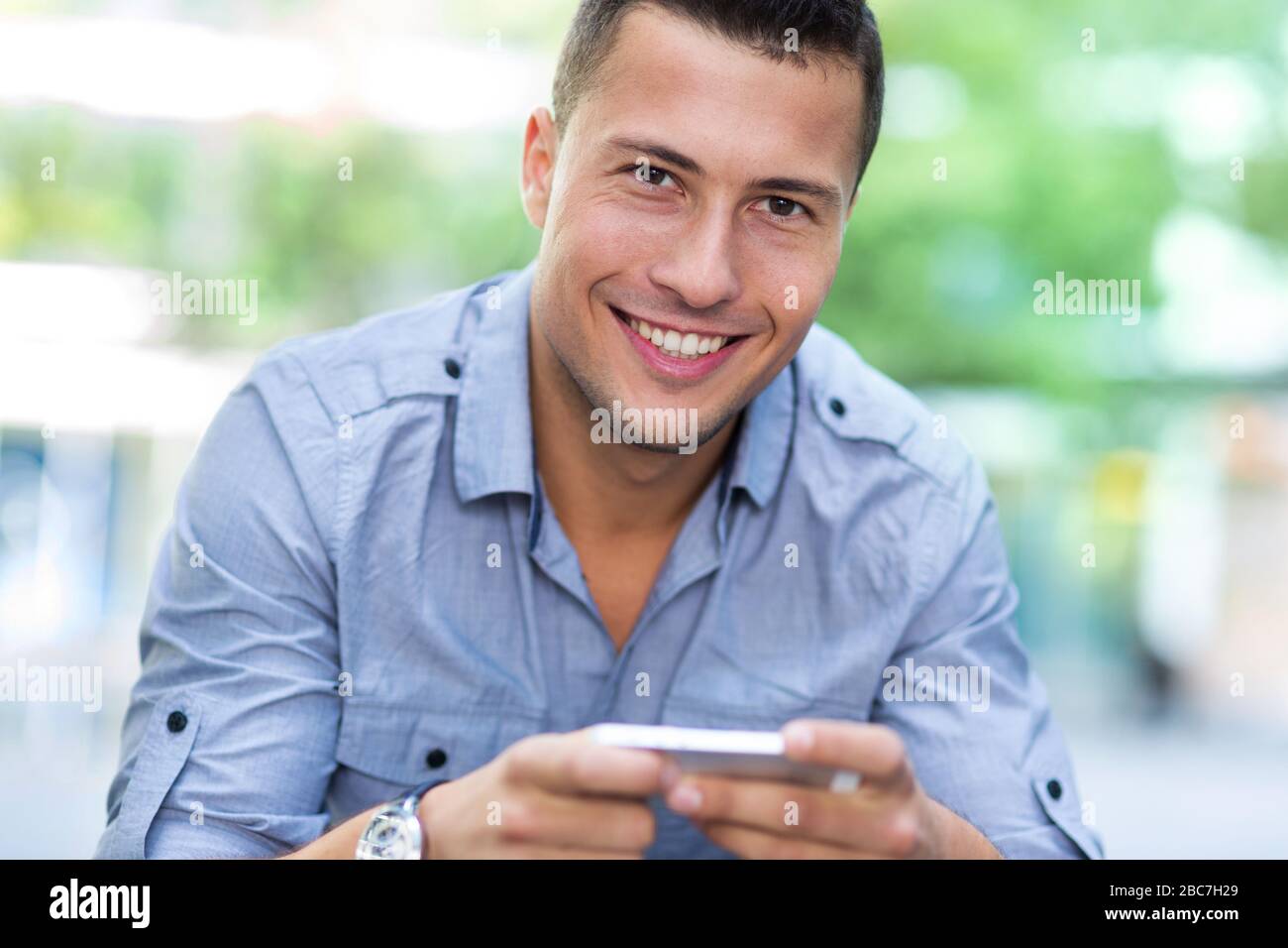 Young man using his smartphone Stock Photo