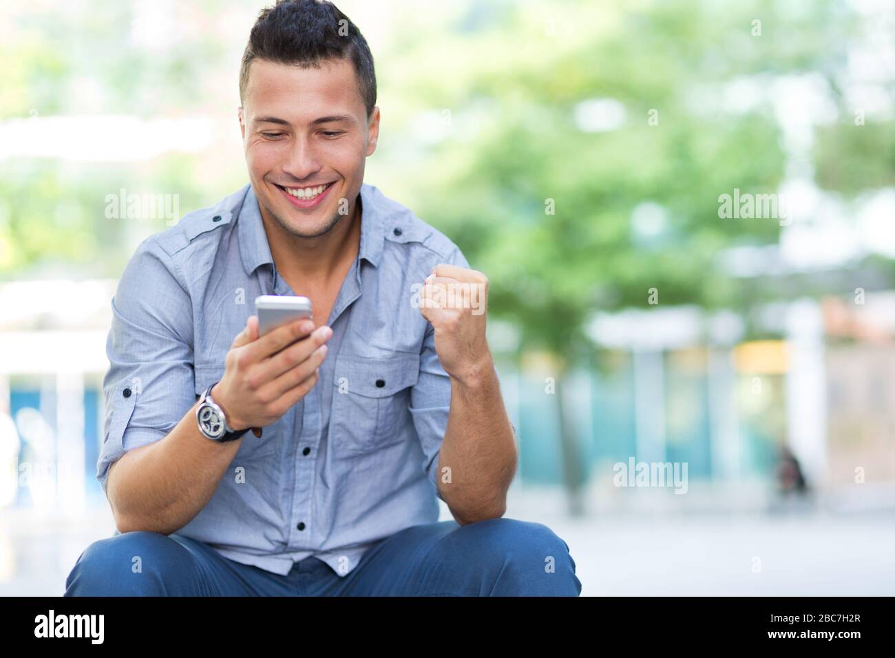 Young man using his smartphone Stock Photo
