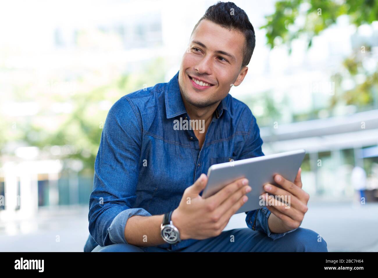 Young man with digital tablet outdoors Stock Photo